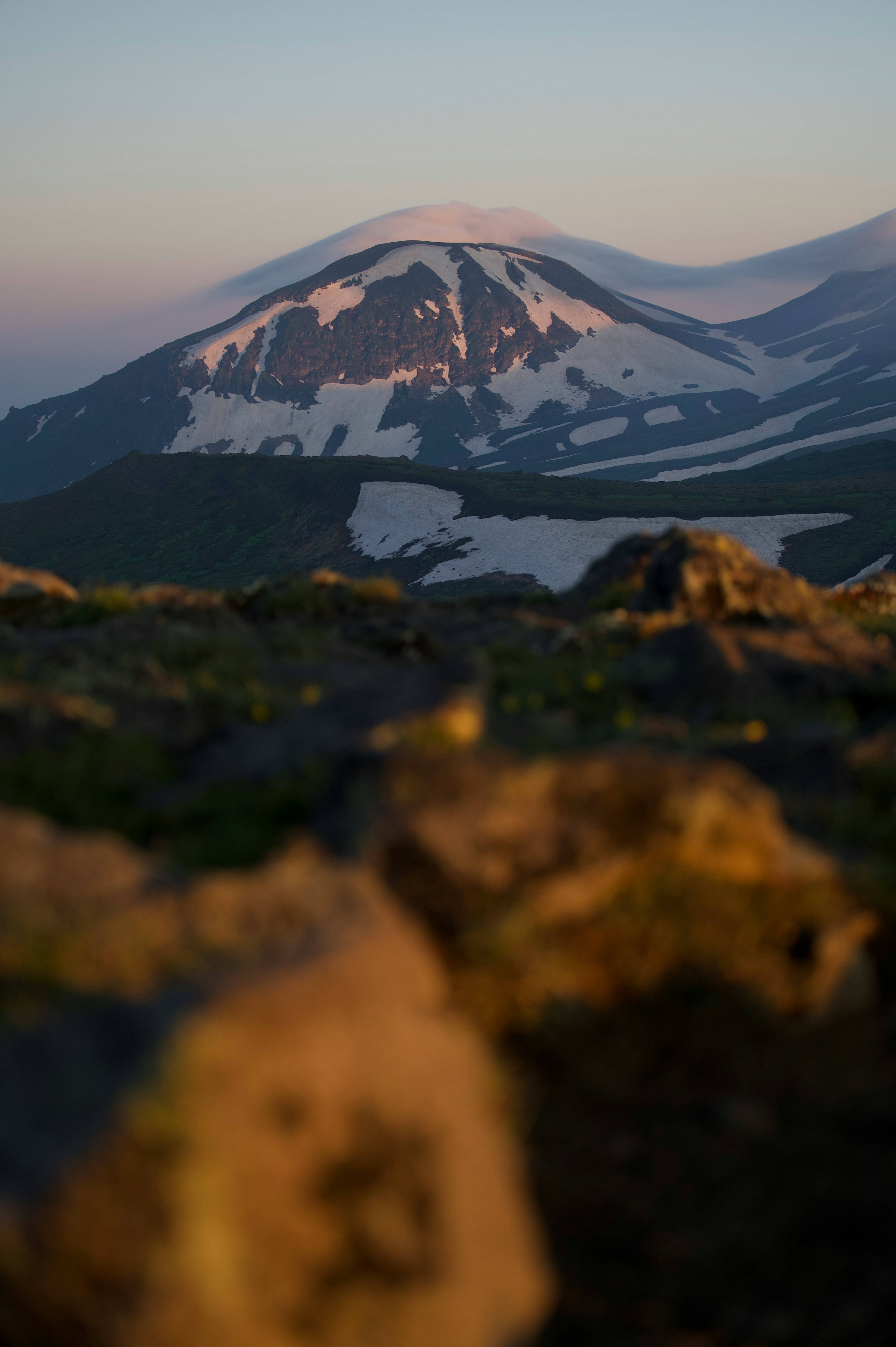 Snow-capped mountain with rocky foreground