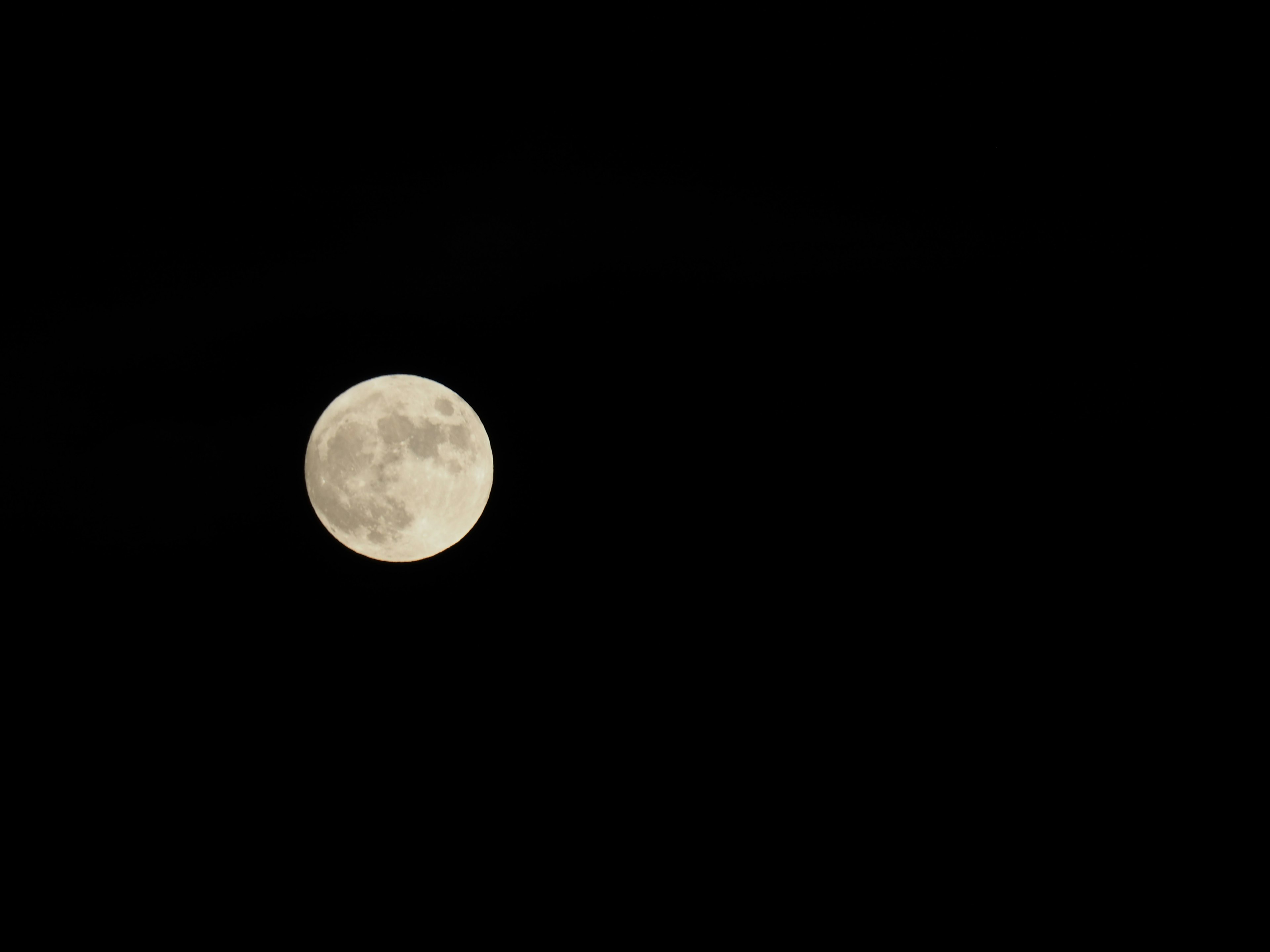 Full moon glowing in a dark sky