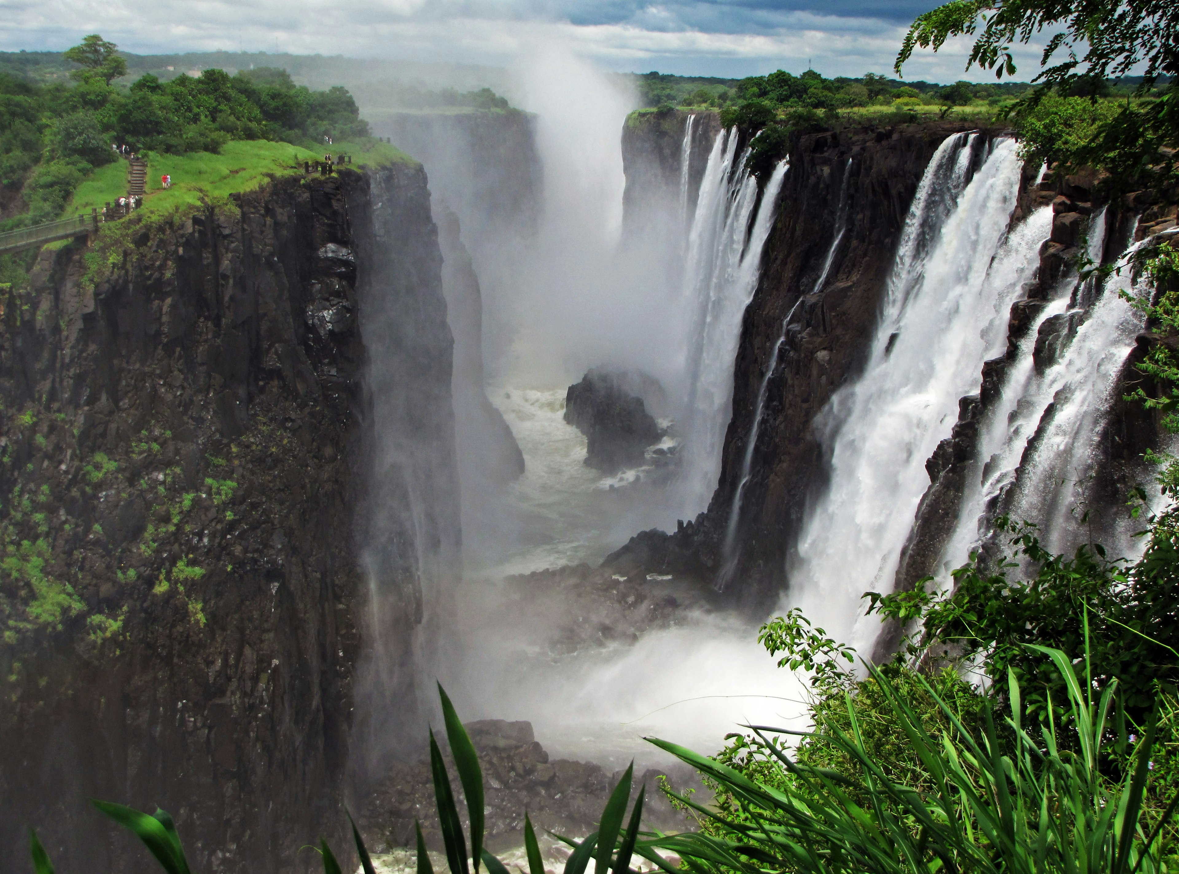 Majestic waterfall view lush greenery and mist