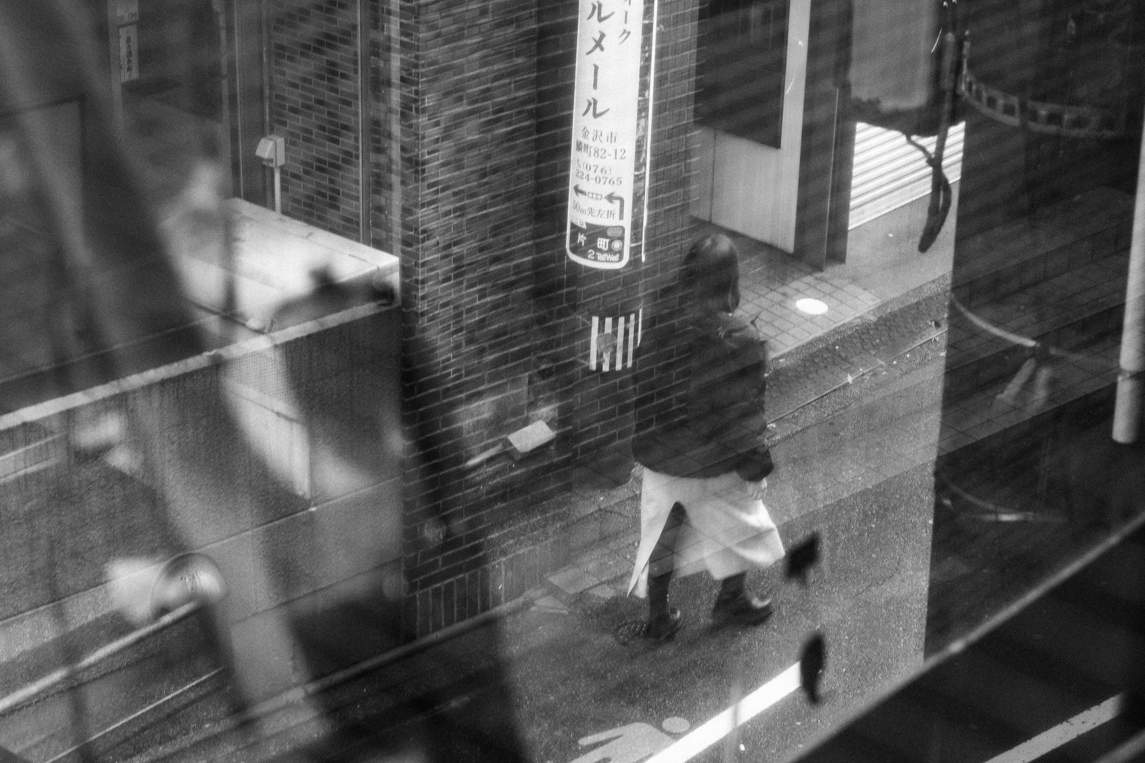 A person walking in a black and white city scene