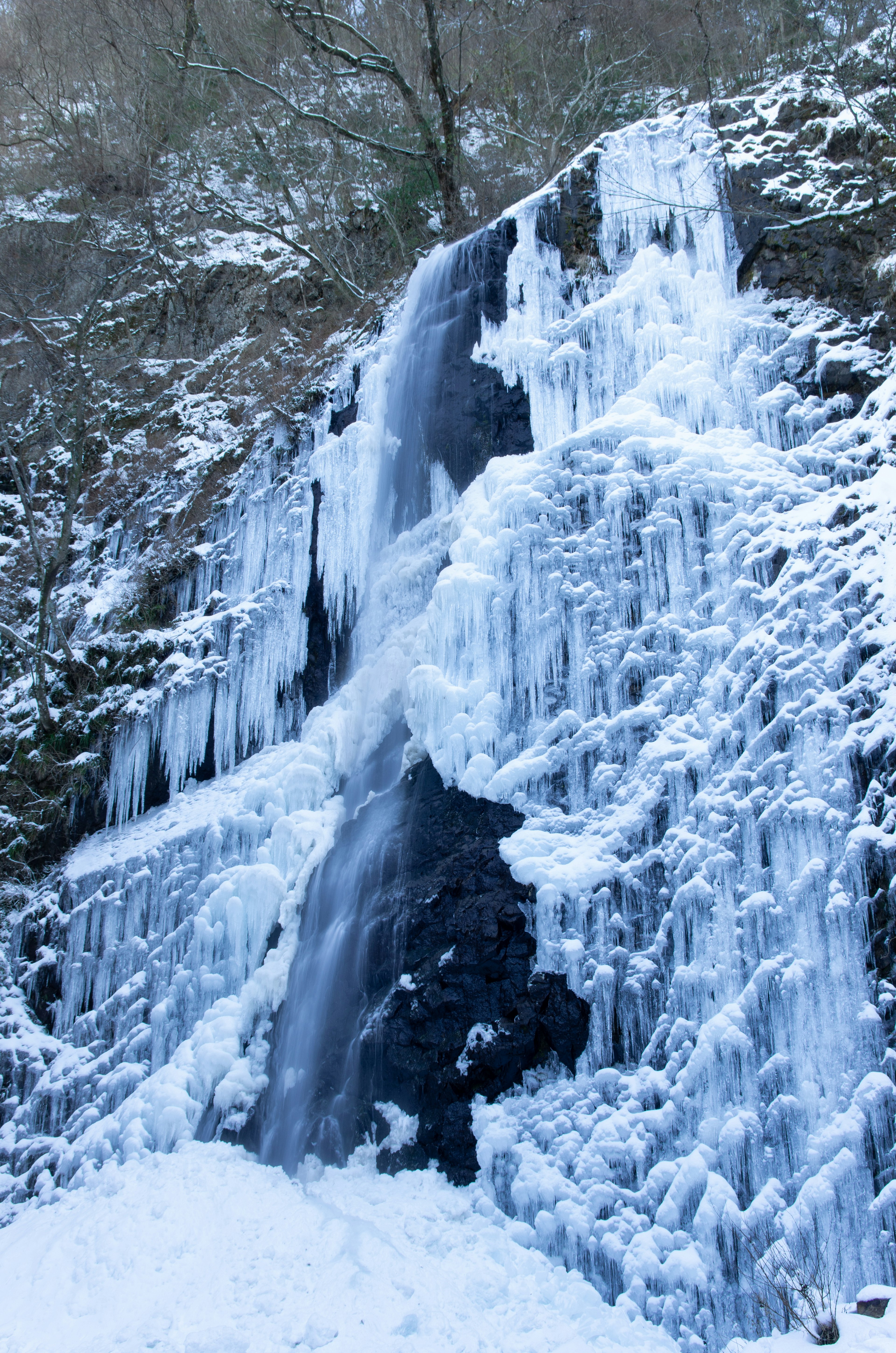 Frozen waterfall with icy blue formations cascading down