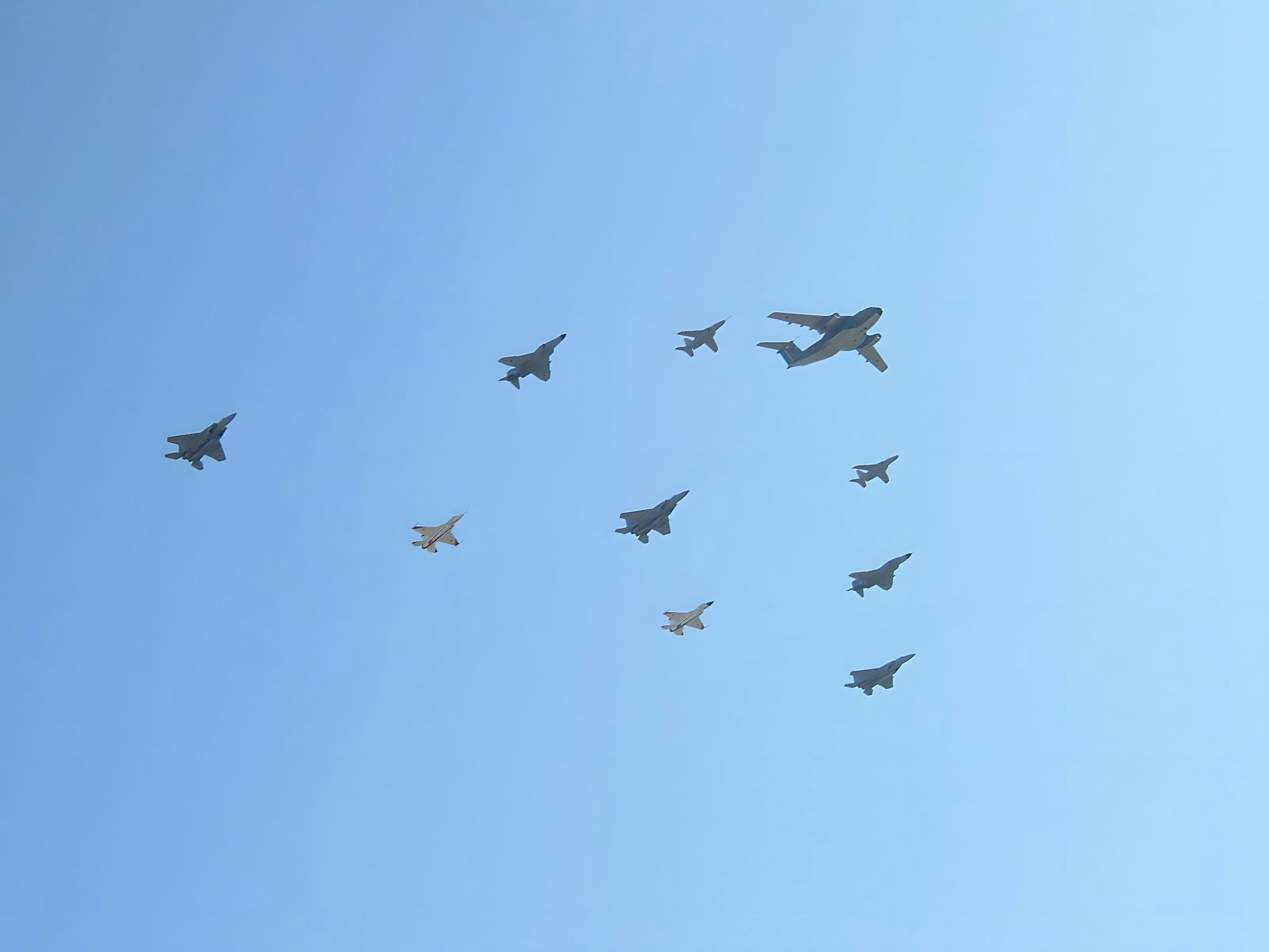 Formation of military aircraft flying in a clear blue sky