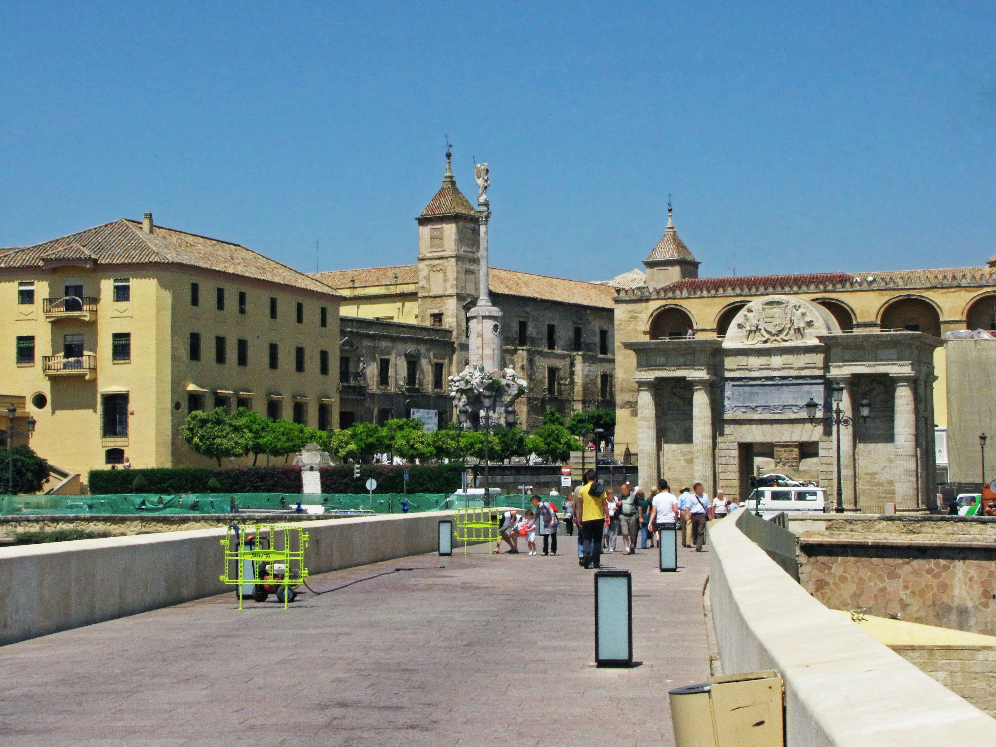 Historic buildings and people walking under a blue sky