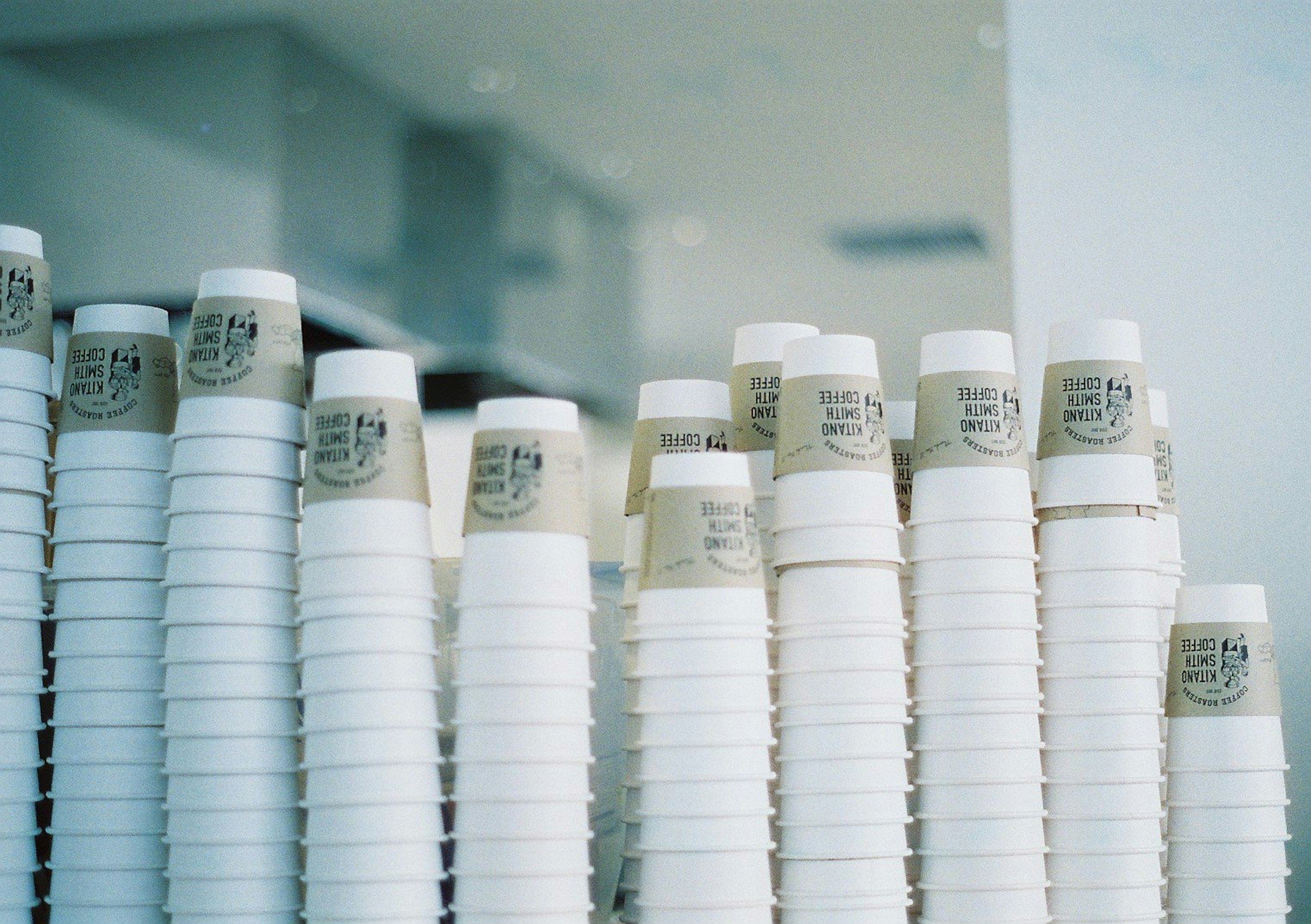 Image of stacked white paper cups with labels