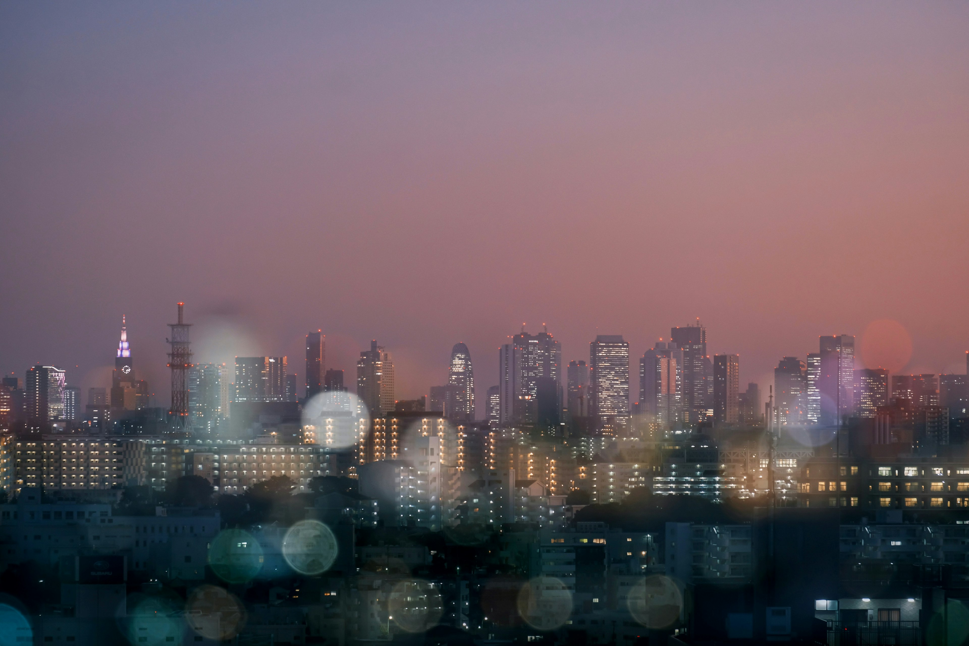 City skyline at sunset with blurred lights