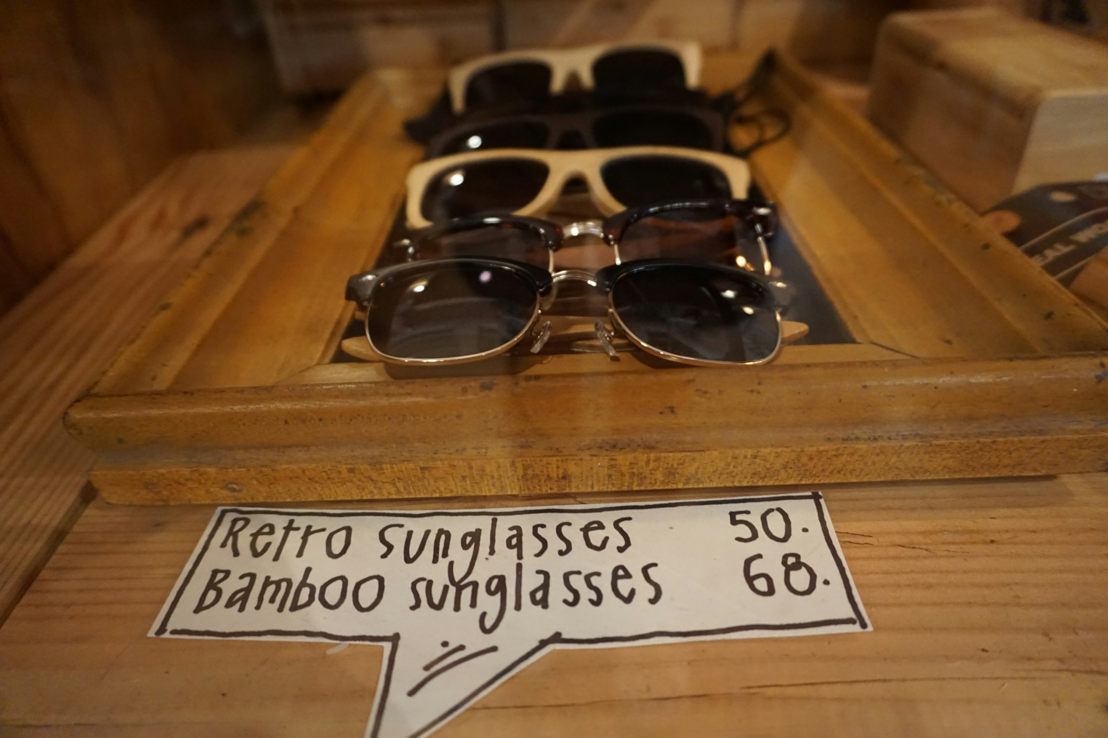 Display of retro sunglasses and bamboo sunglasses with price tags