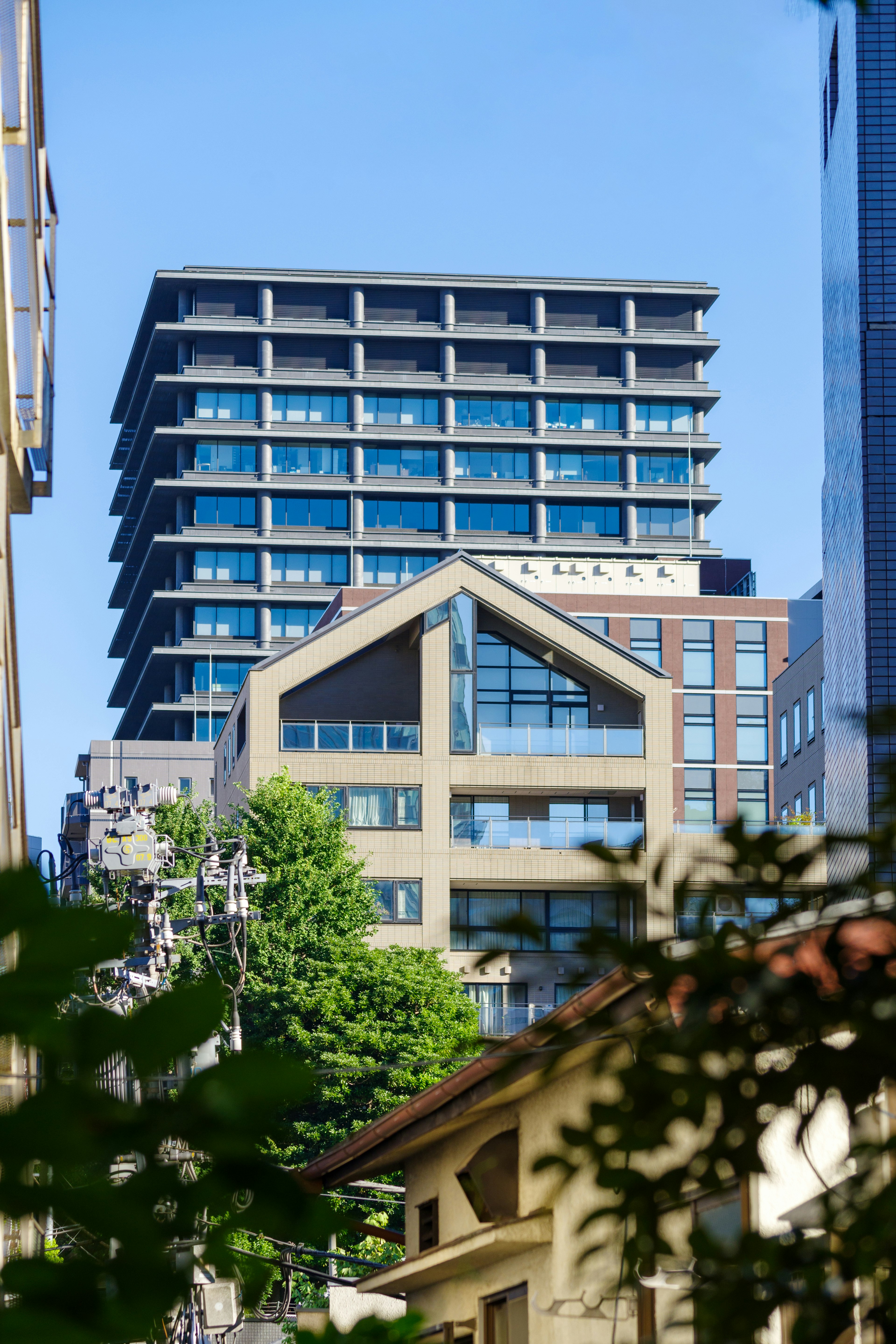 Urban landscape featuring a modern high-rise building and a uniquely shaped structure