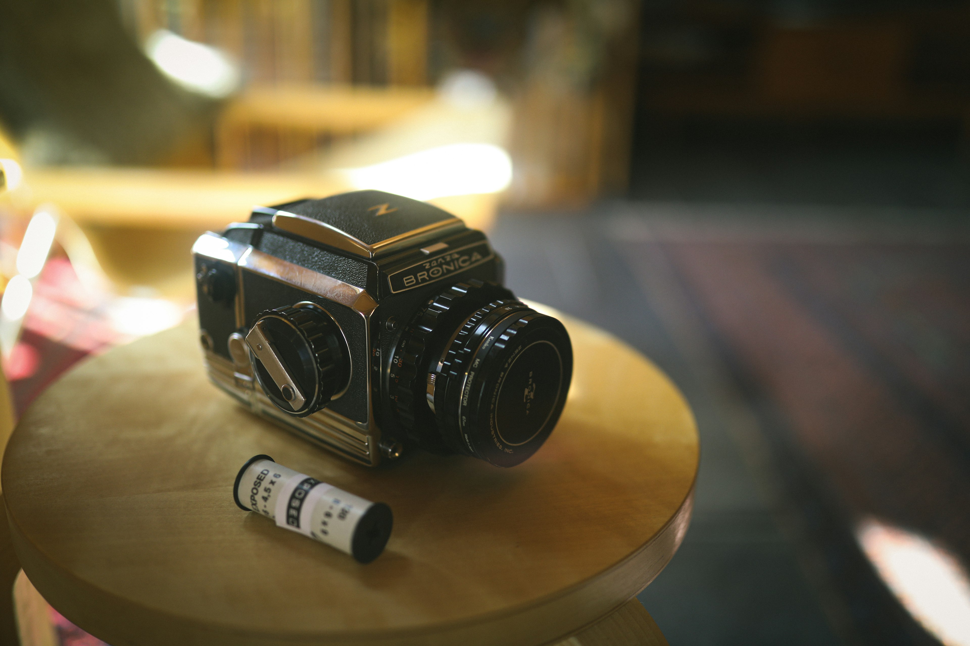 An old camera and film placed on a table