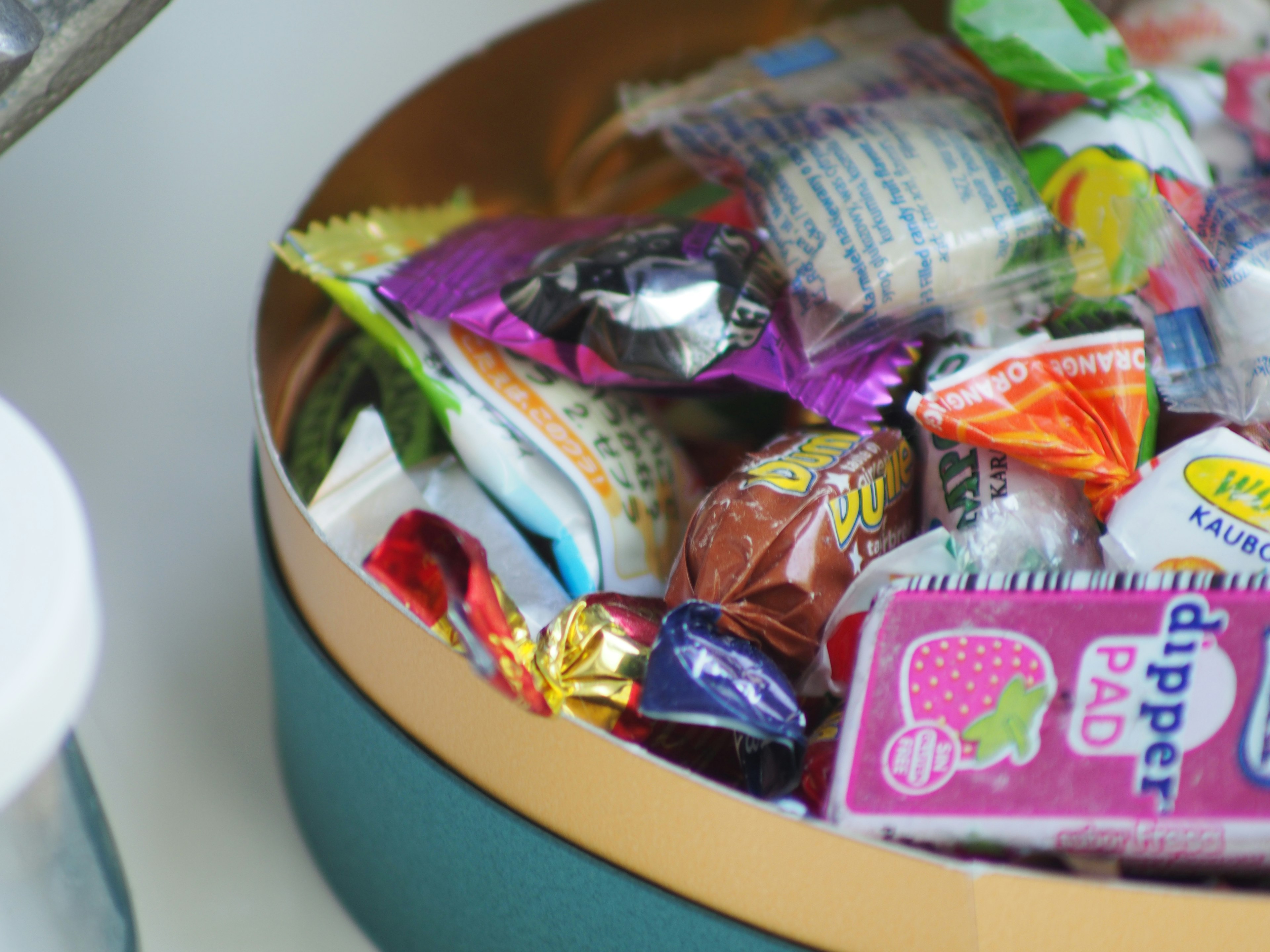 Colorful candies packed in a round tin container