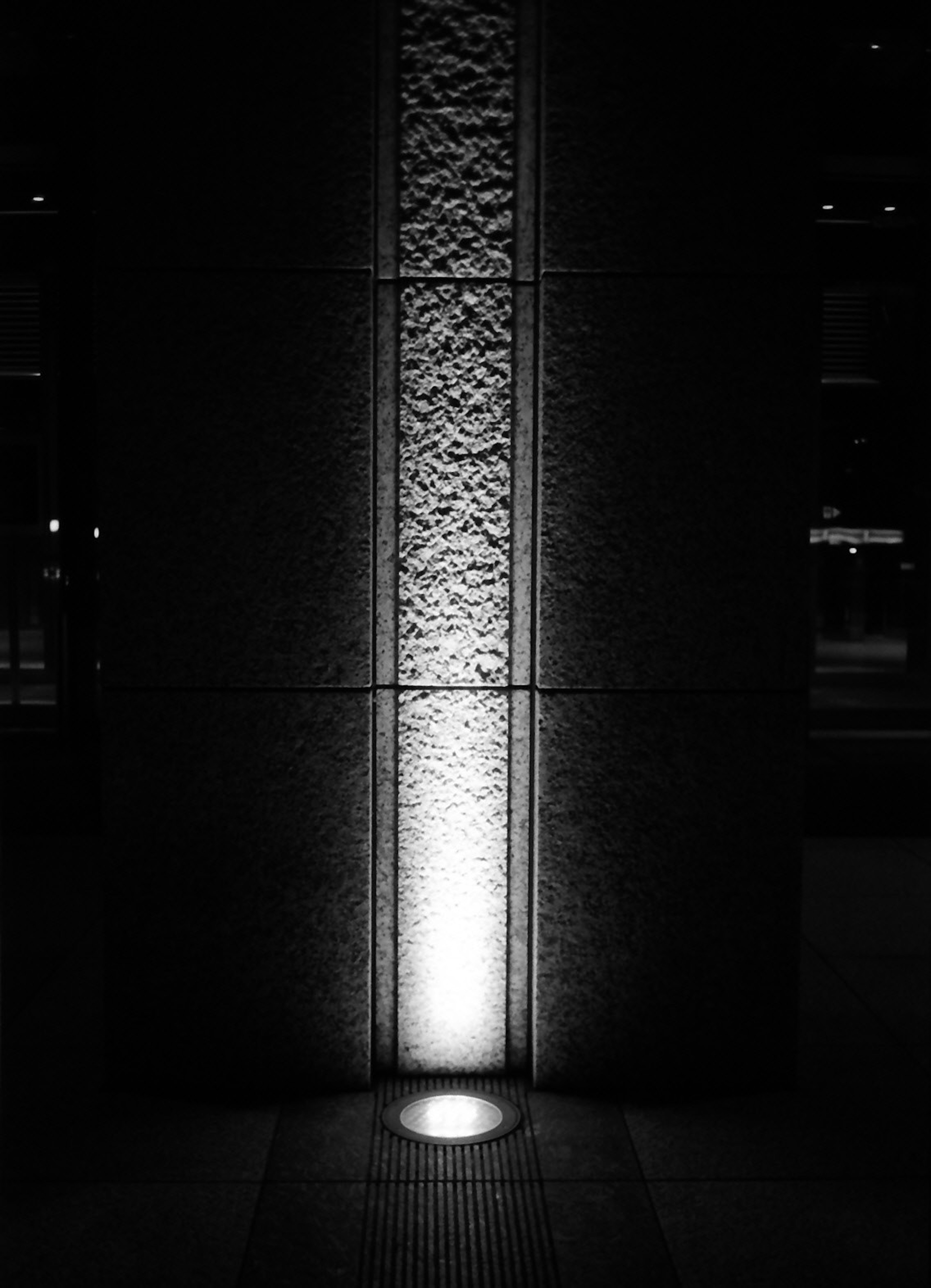 Decorative column illuminated against a dark background