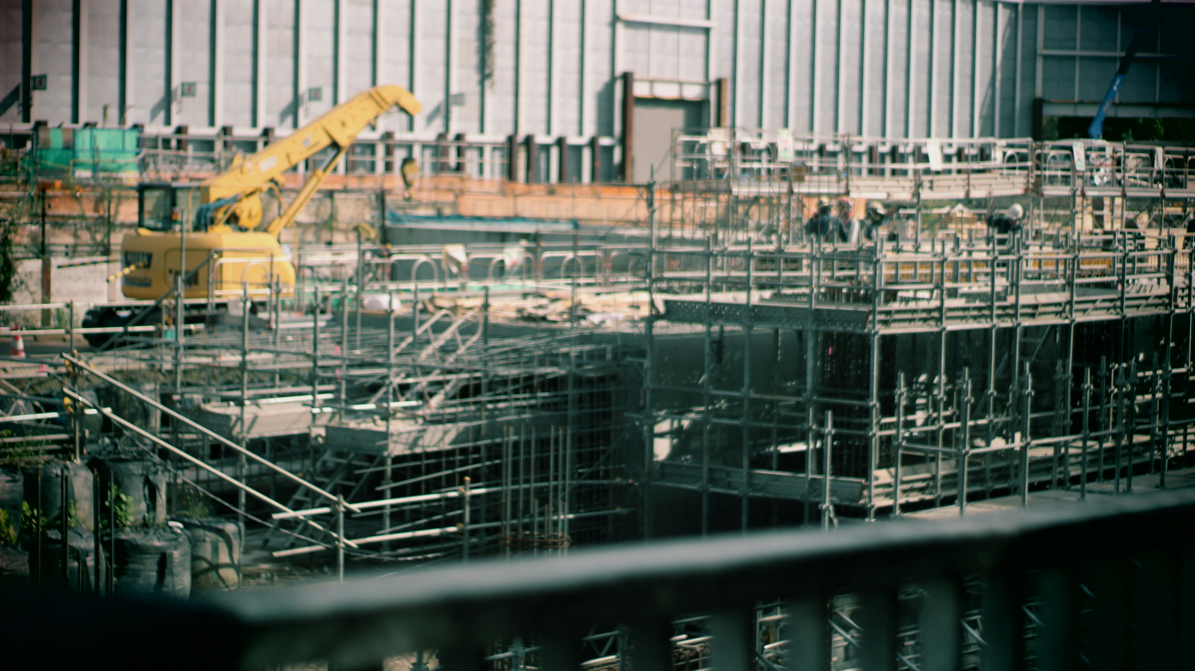 Overview of a construction site with scaffolding and a crane