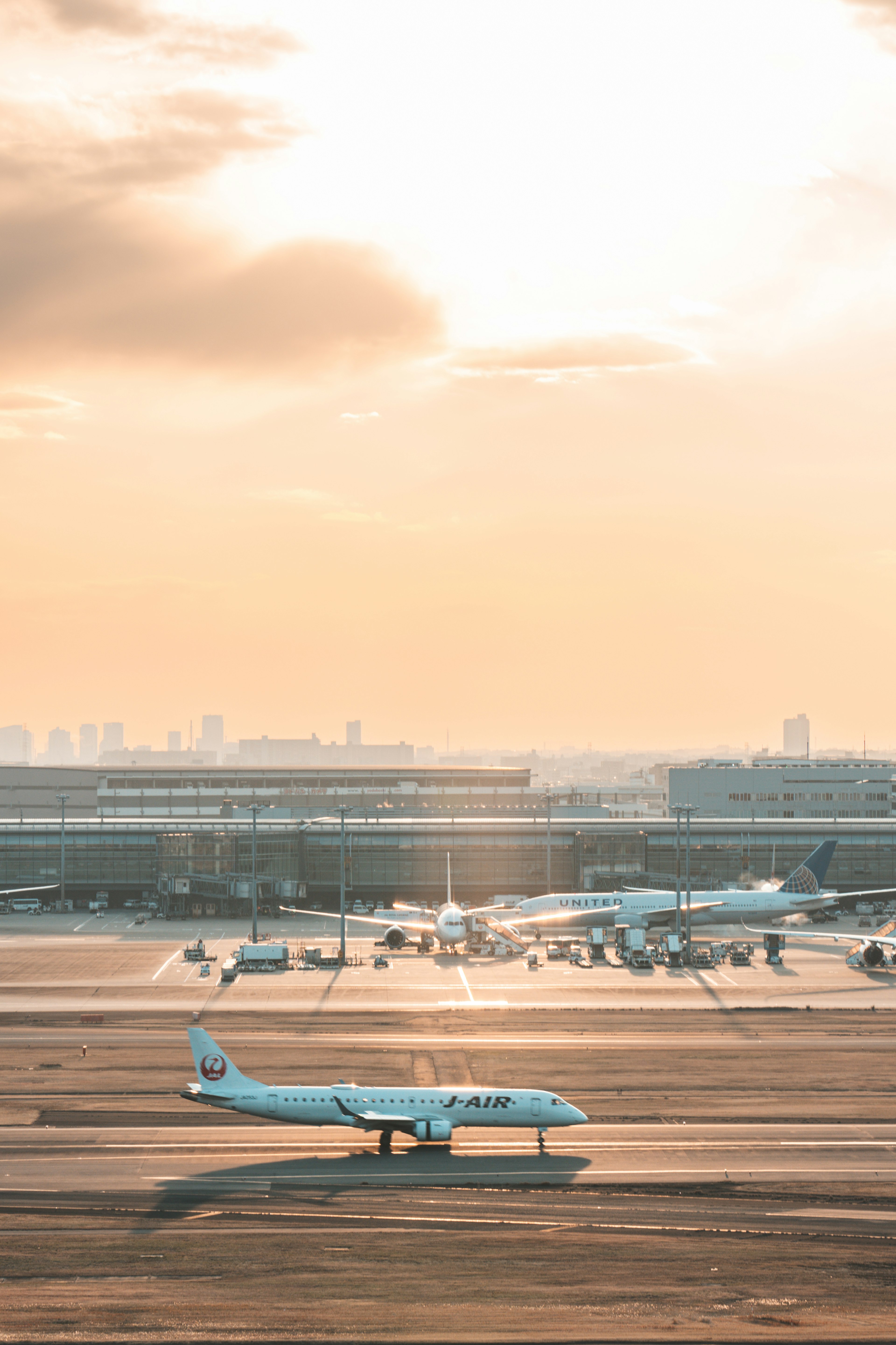 Small aircraft on airport runway with sunset view