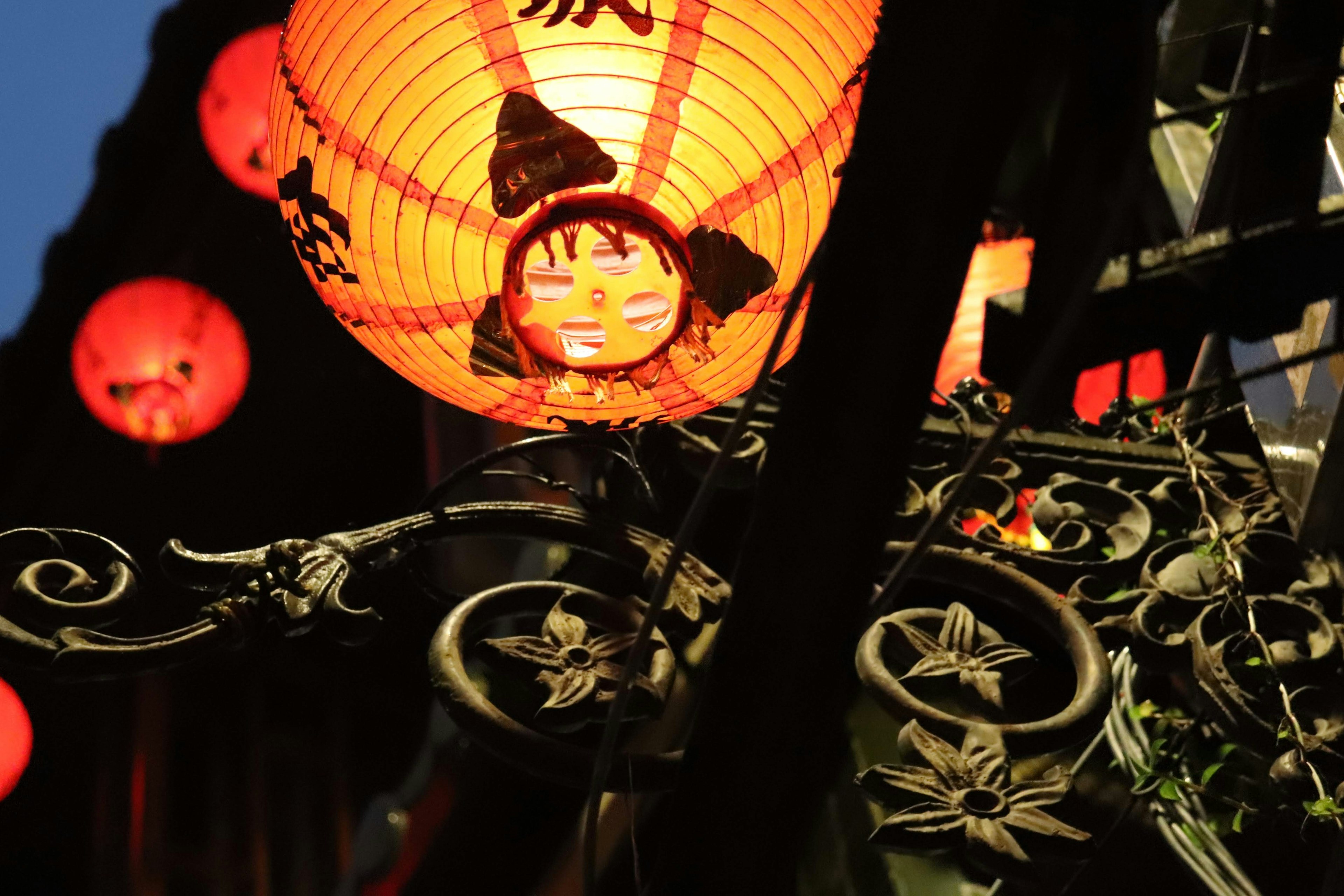 Image featuring a red lantern with intricate details and decorative metal frame