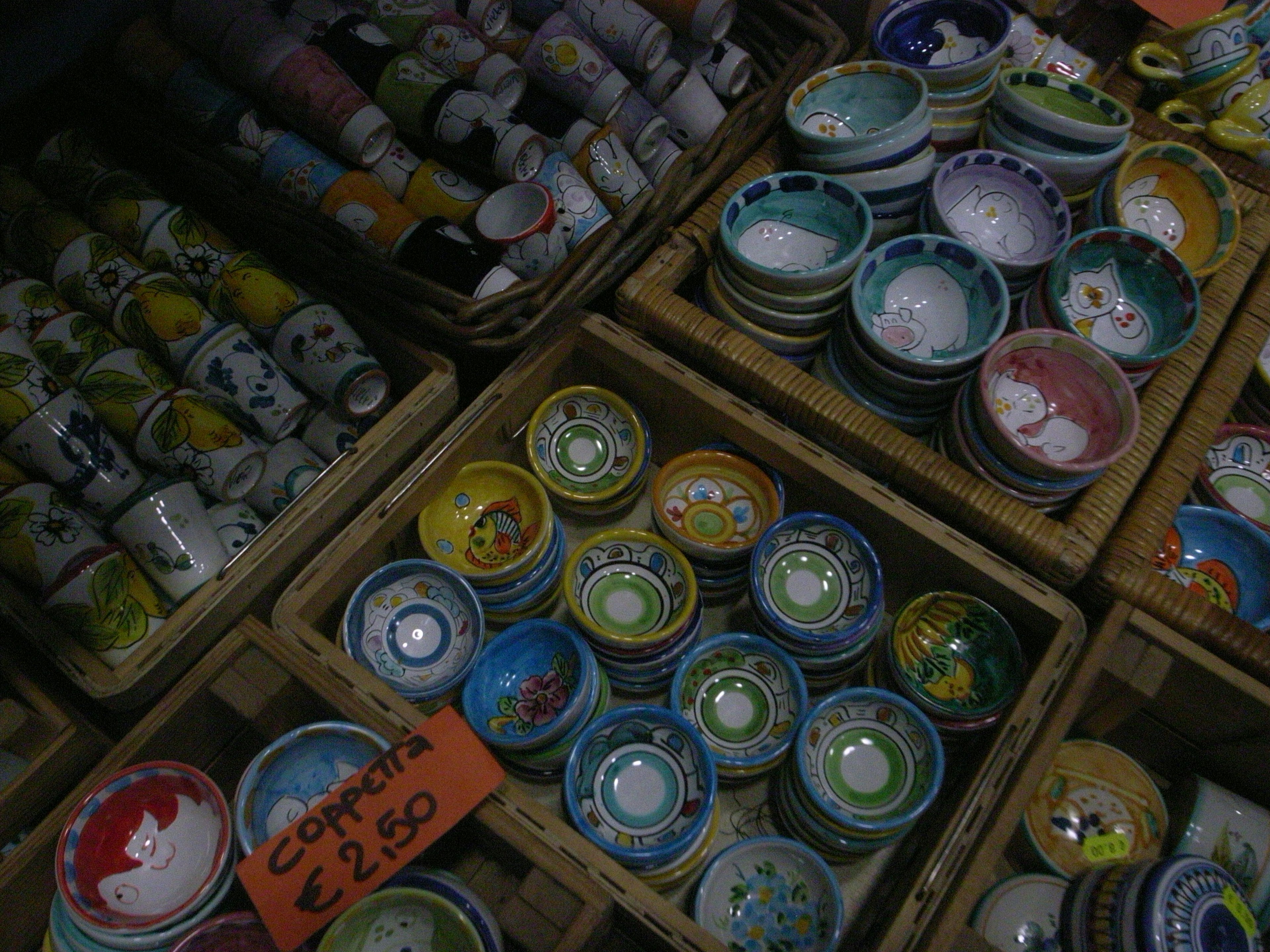 Colorful ceramic bowls displayed in a market setting