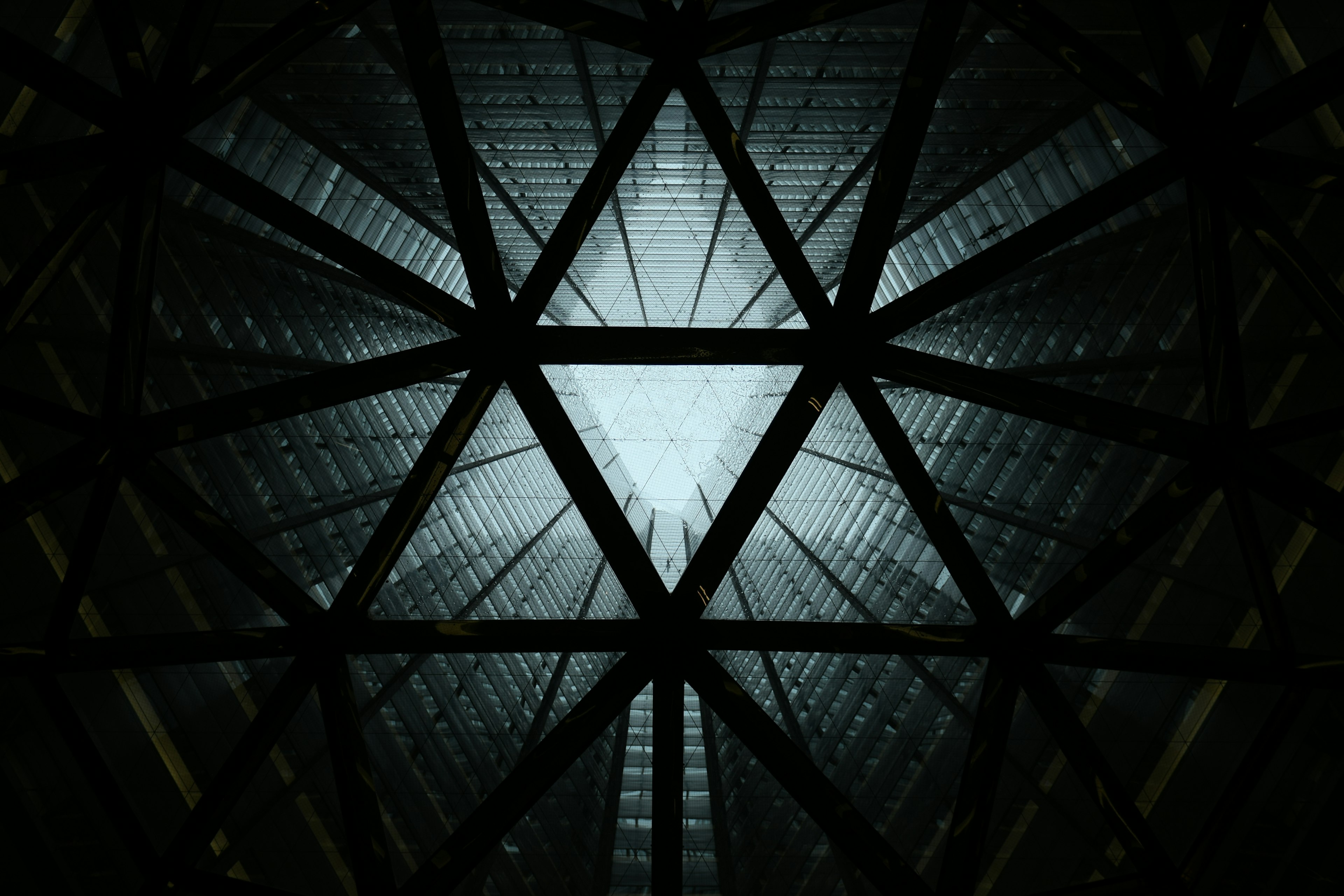 View looking up at a hexagonal structure with light shining through