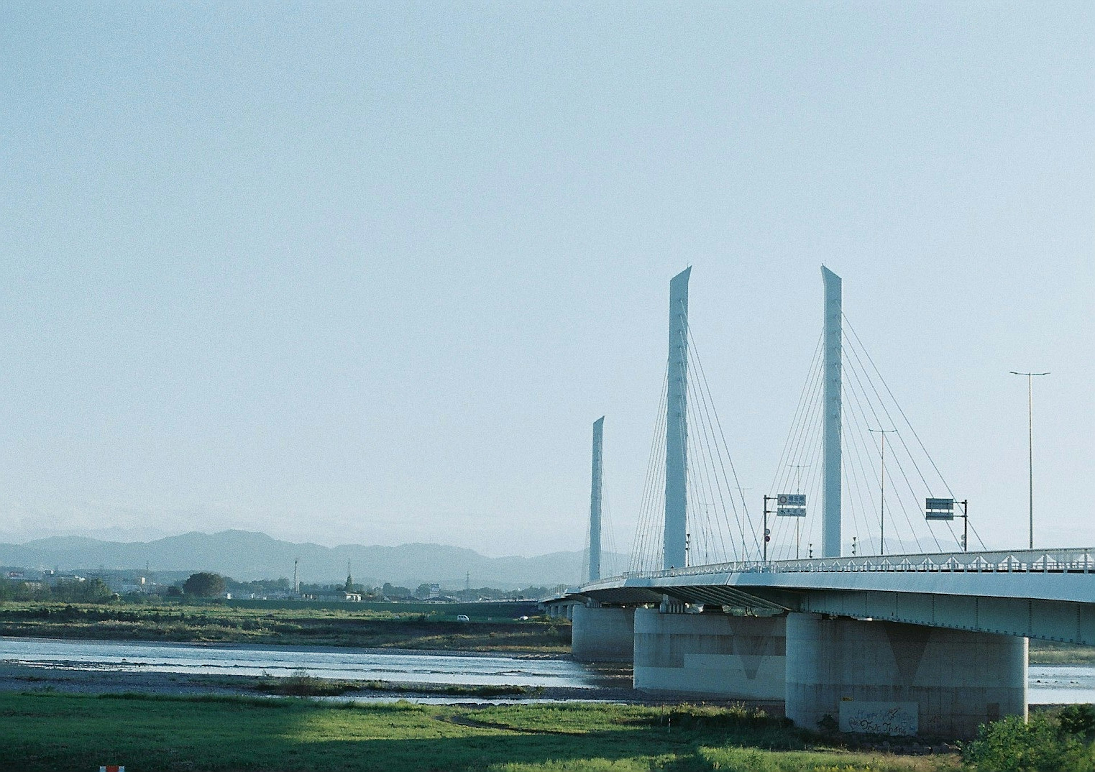 青空の下にある現代的な橋と川の風景