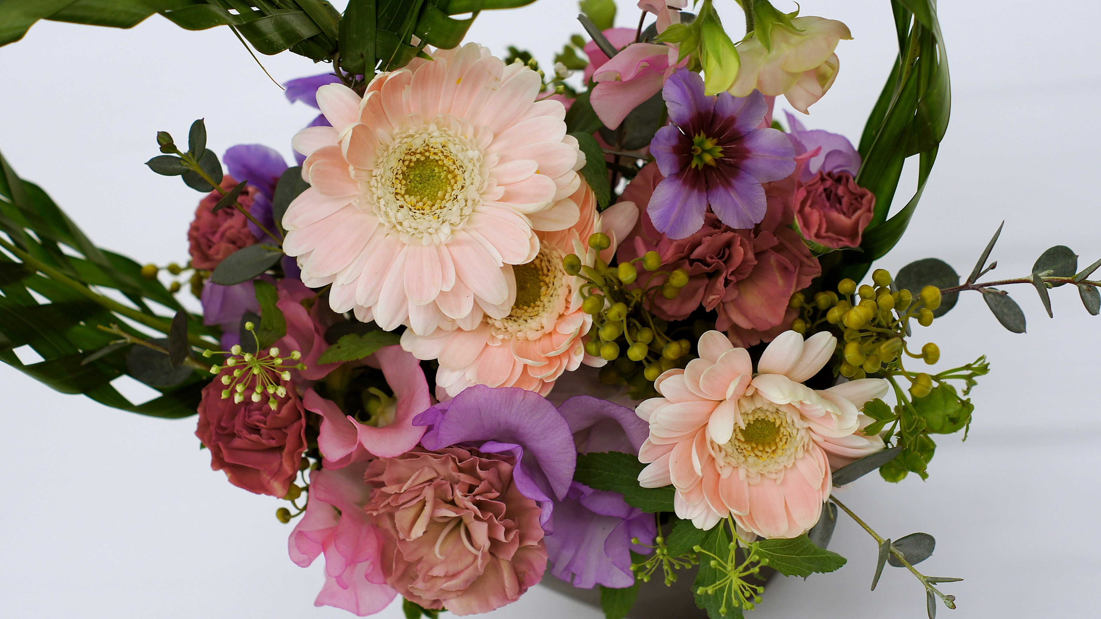 A beautiful arrangement of colorful flowers featuring pink and purple blooms prominently