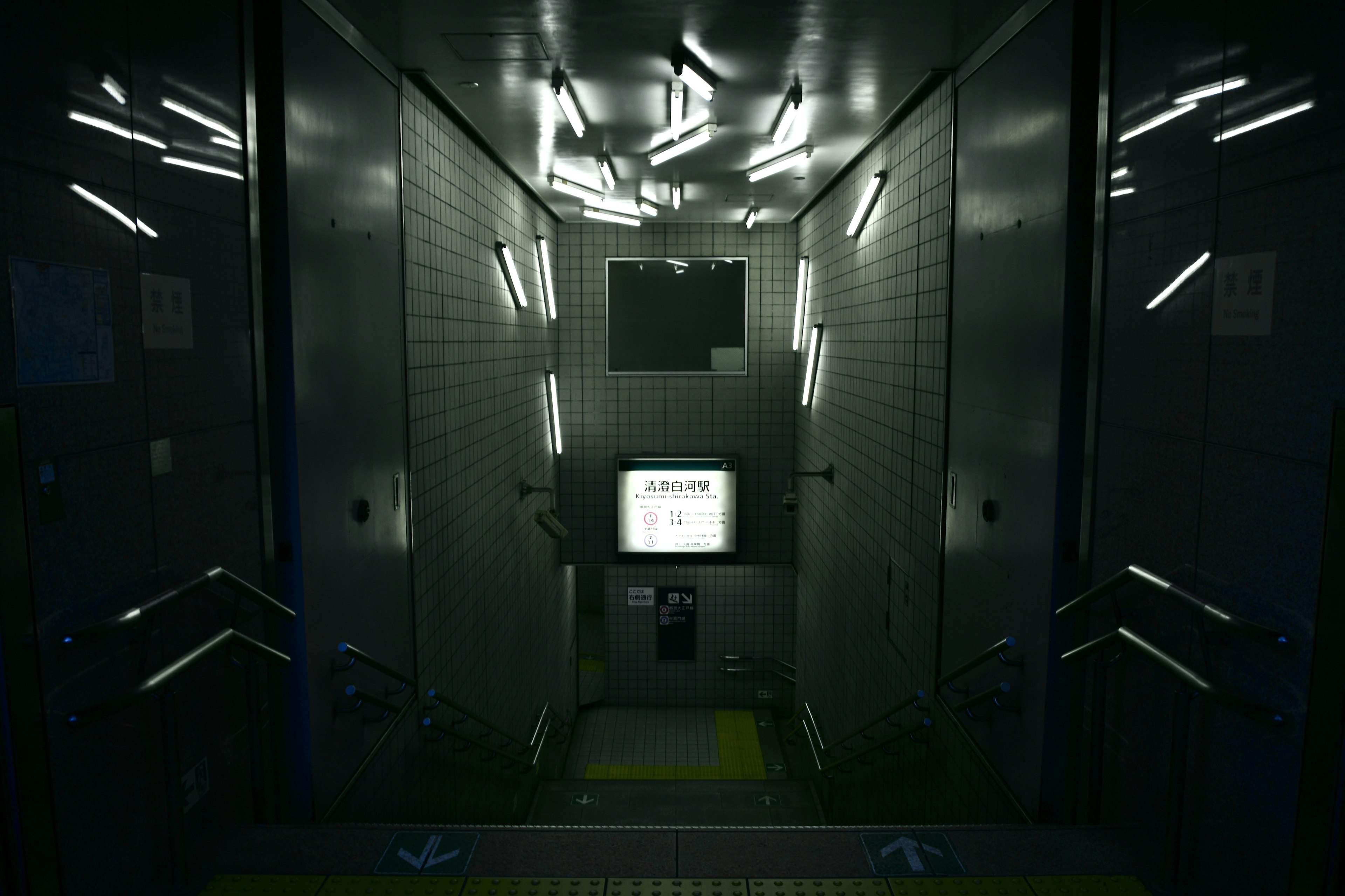 Interior of a dark elevator featuring a white monitor and glowing strip lights