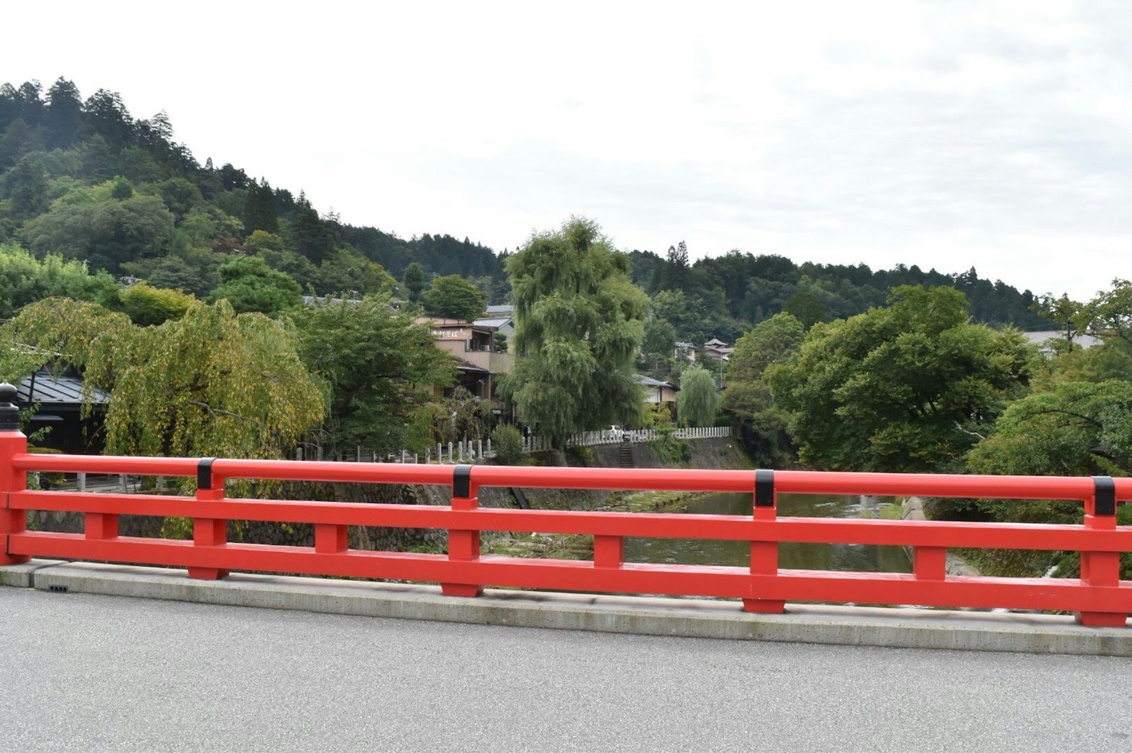 Scenic view featuring a red bridge and lush greenery