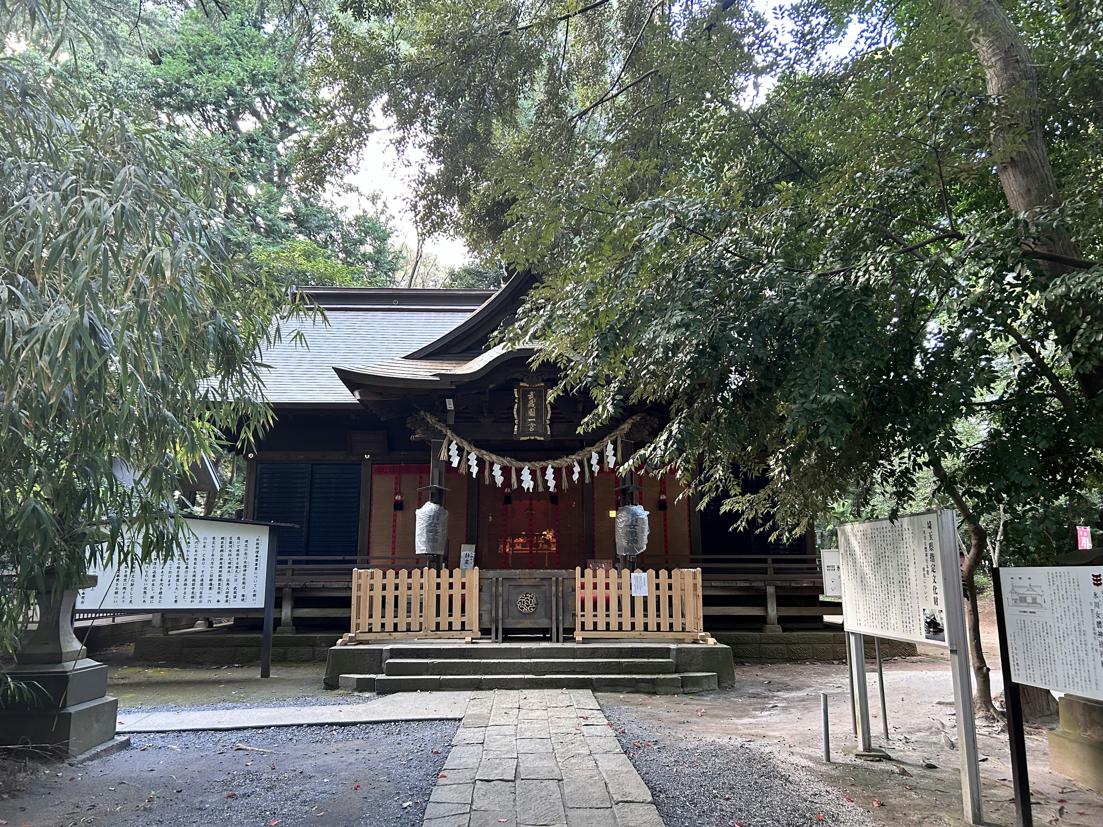 A shrine surrounded by trees with a wooden entrance