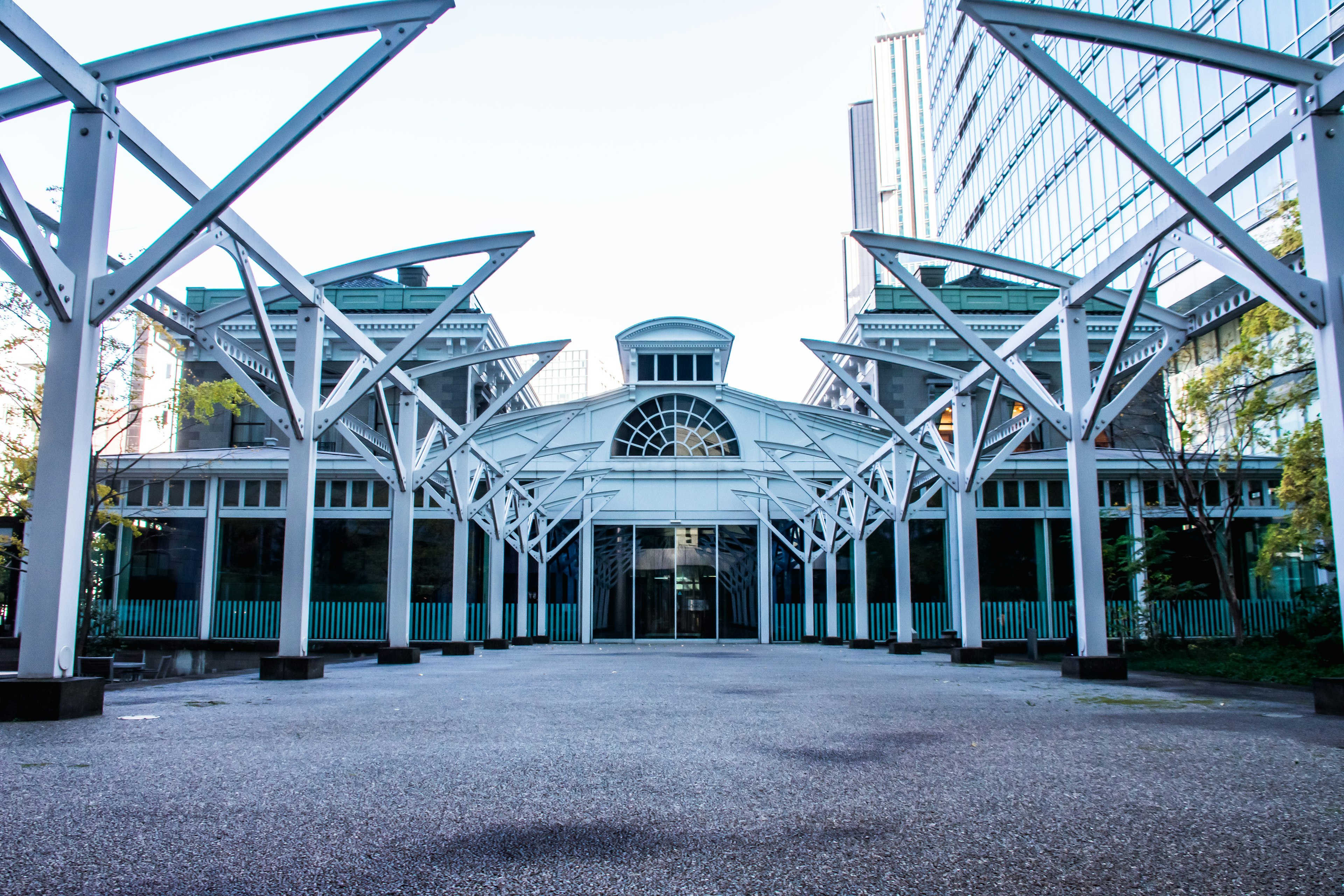 Modern building entrance featuring white metal structures and glass elements