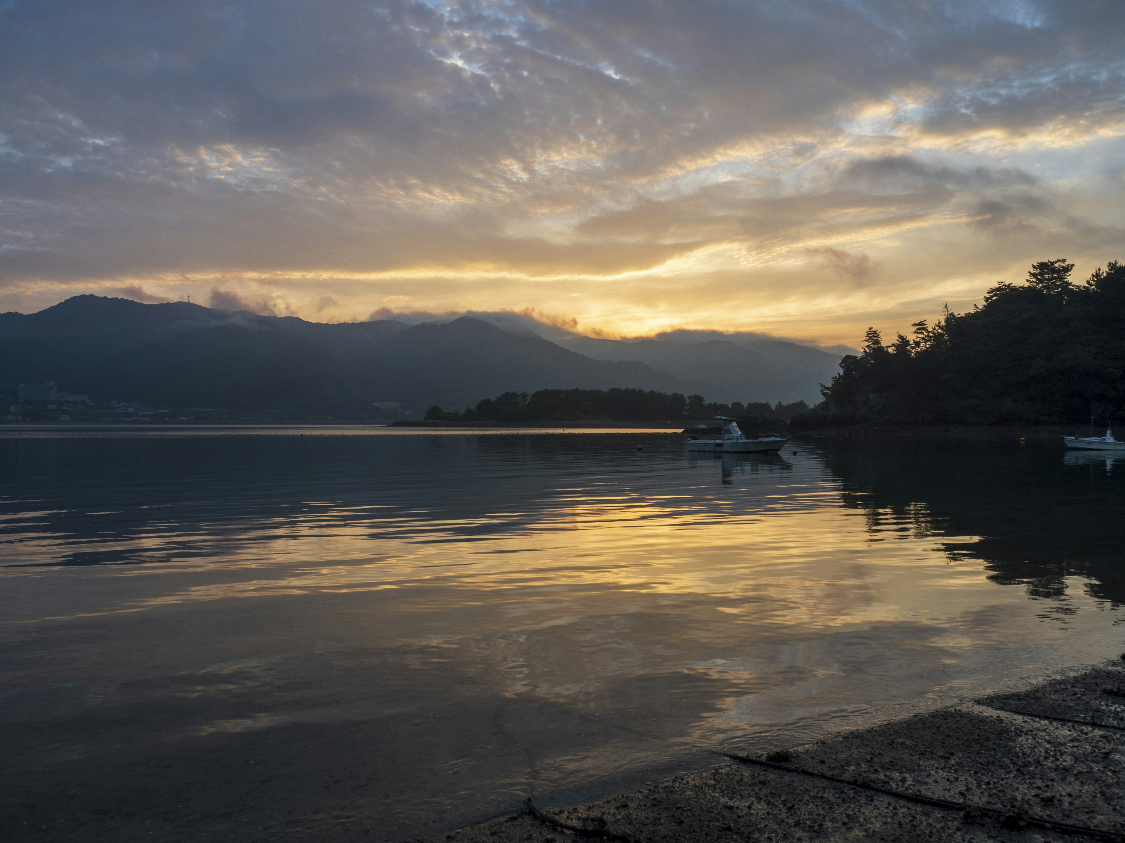 Scenic sunset over a lake reflecting mountains and tranquil waters