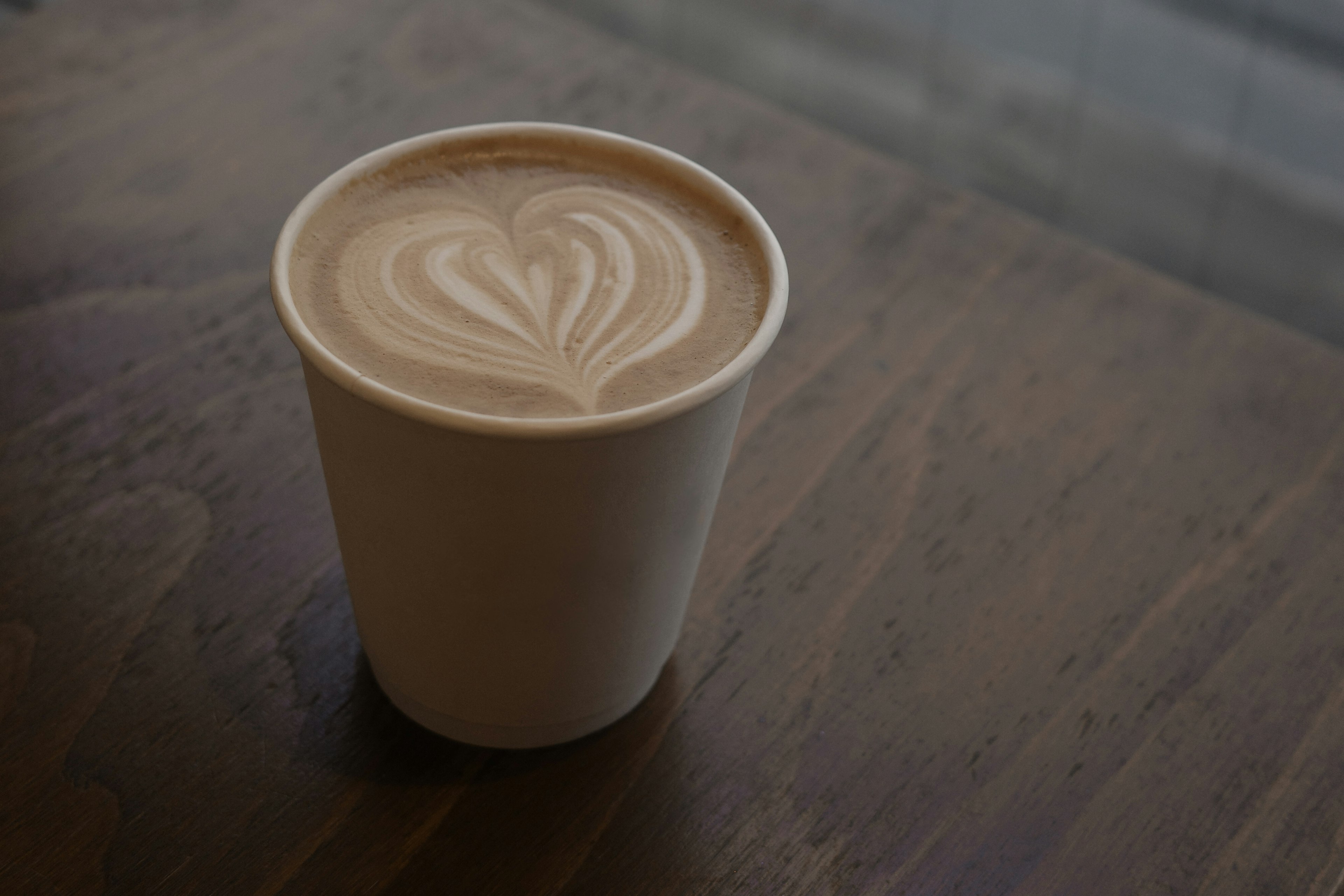 A coffee cup with heart-shaped latte art on top