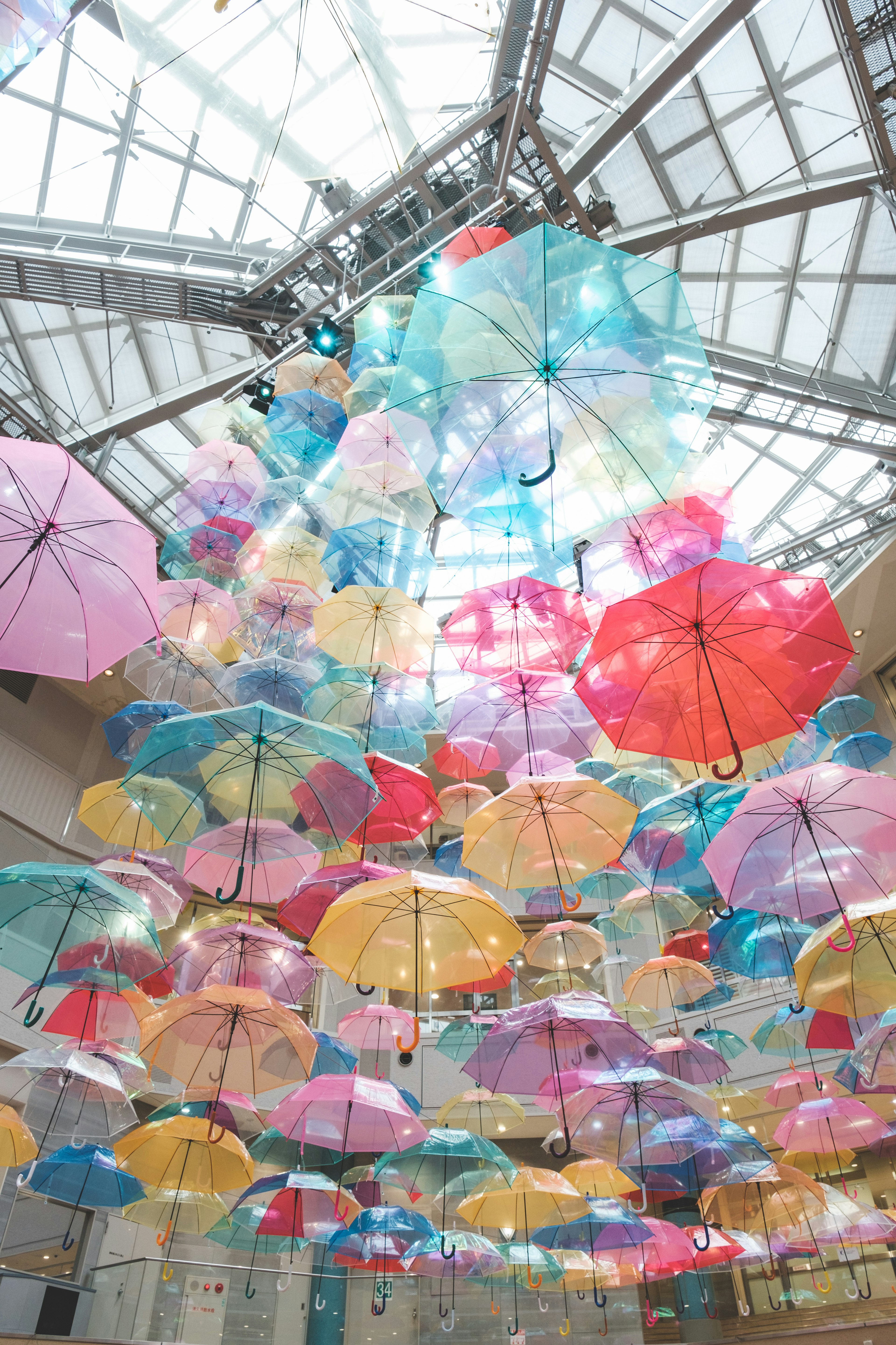 Colorful umbrellas suspended from the ceiling in a vibrant art installation