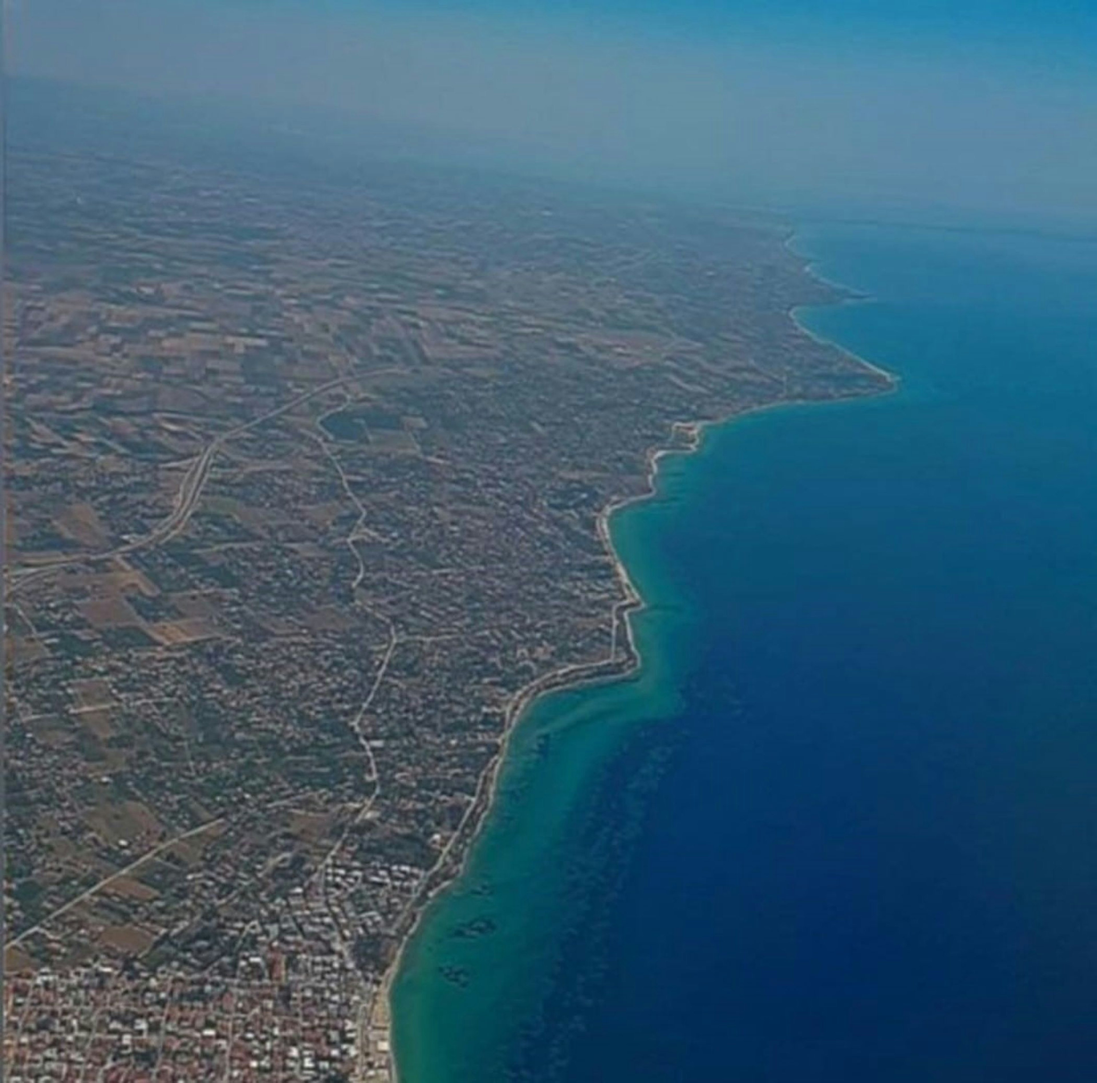 Aerial view of coastline and green landscape