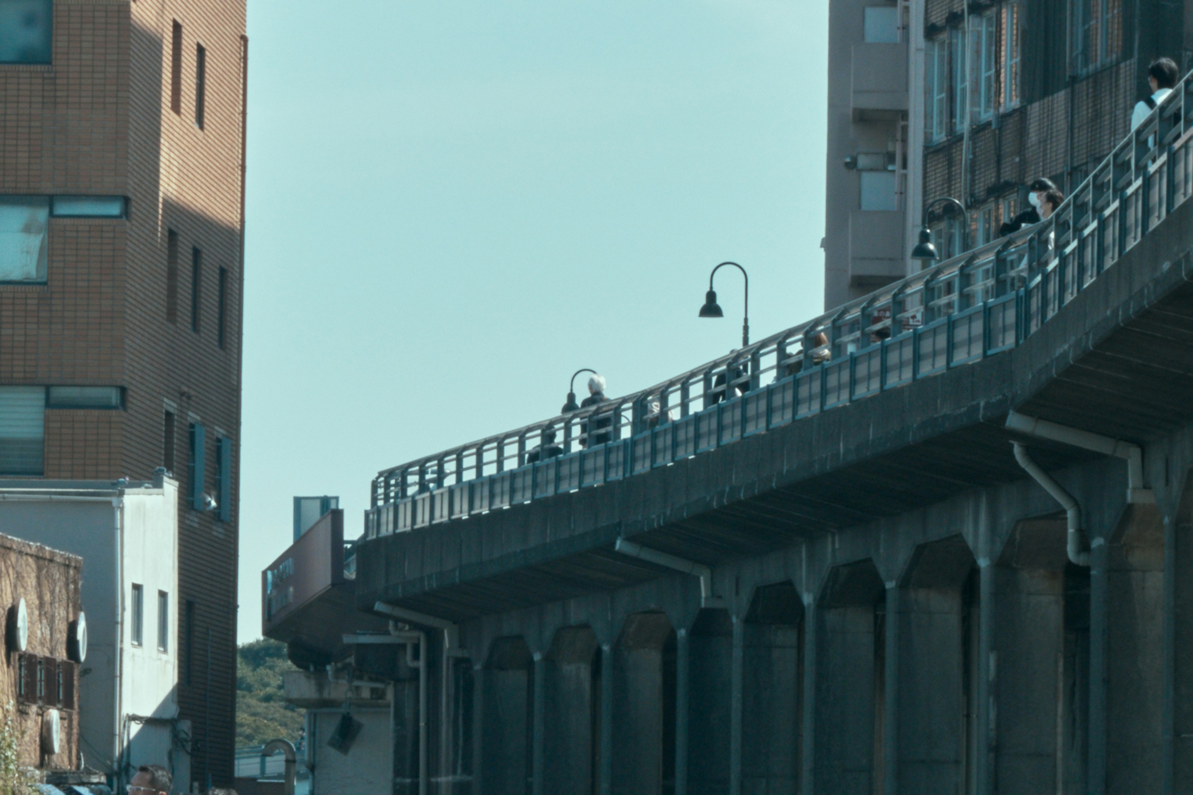 Scene featuring an elevated walkway and adjacent buildings