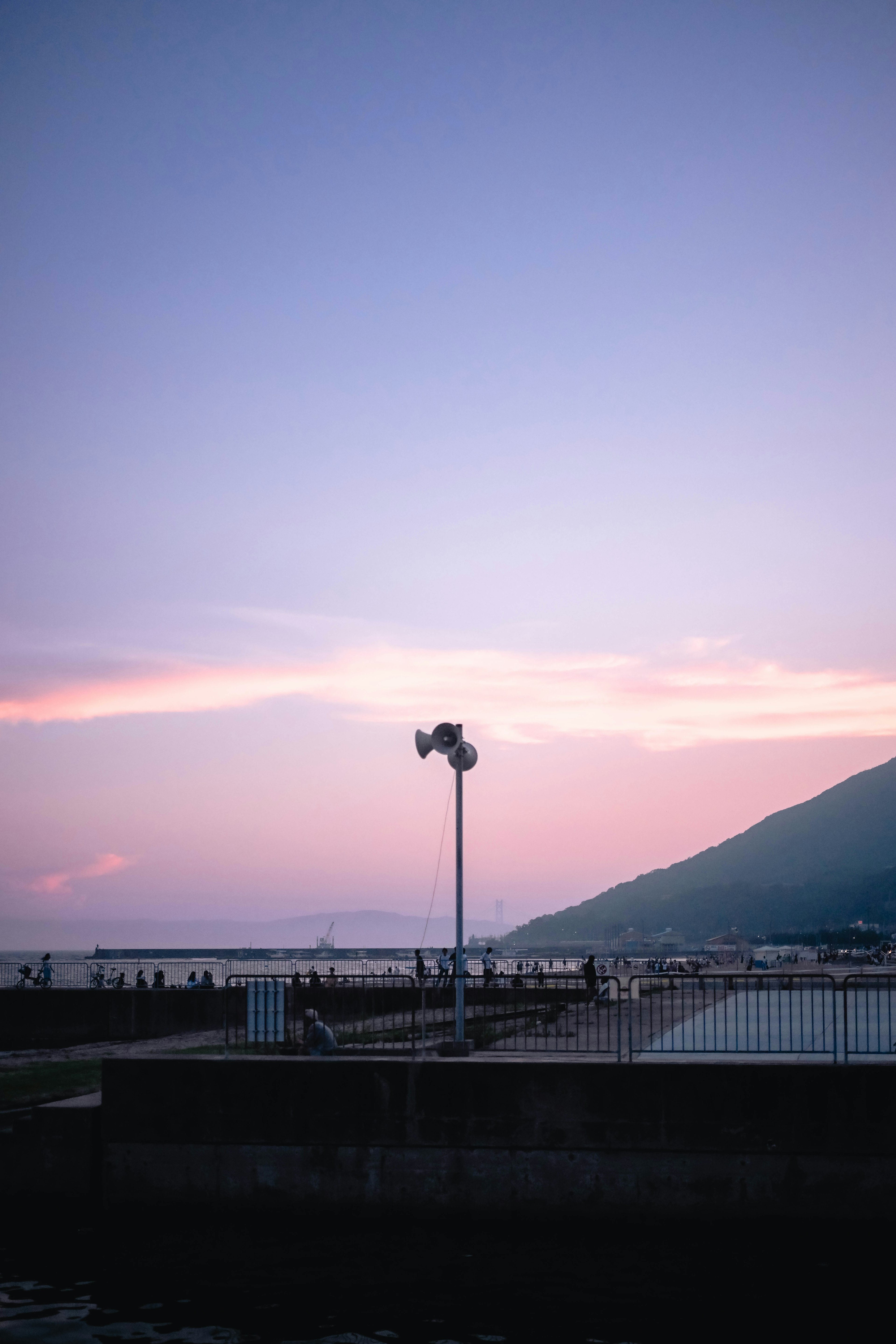 Coastal landscape with a mountain and a sunset sky