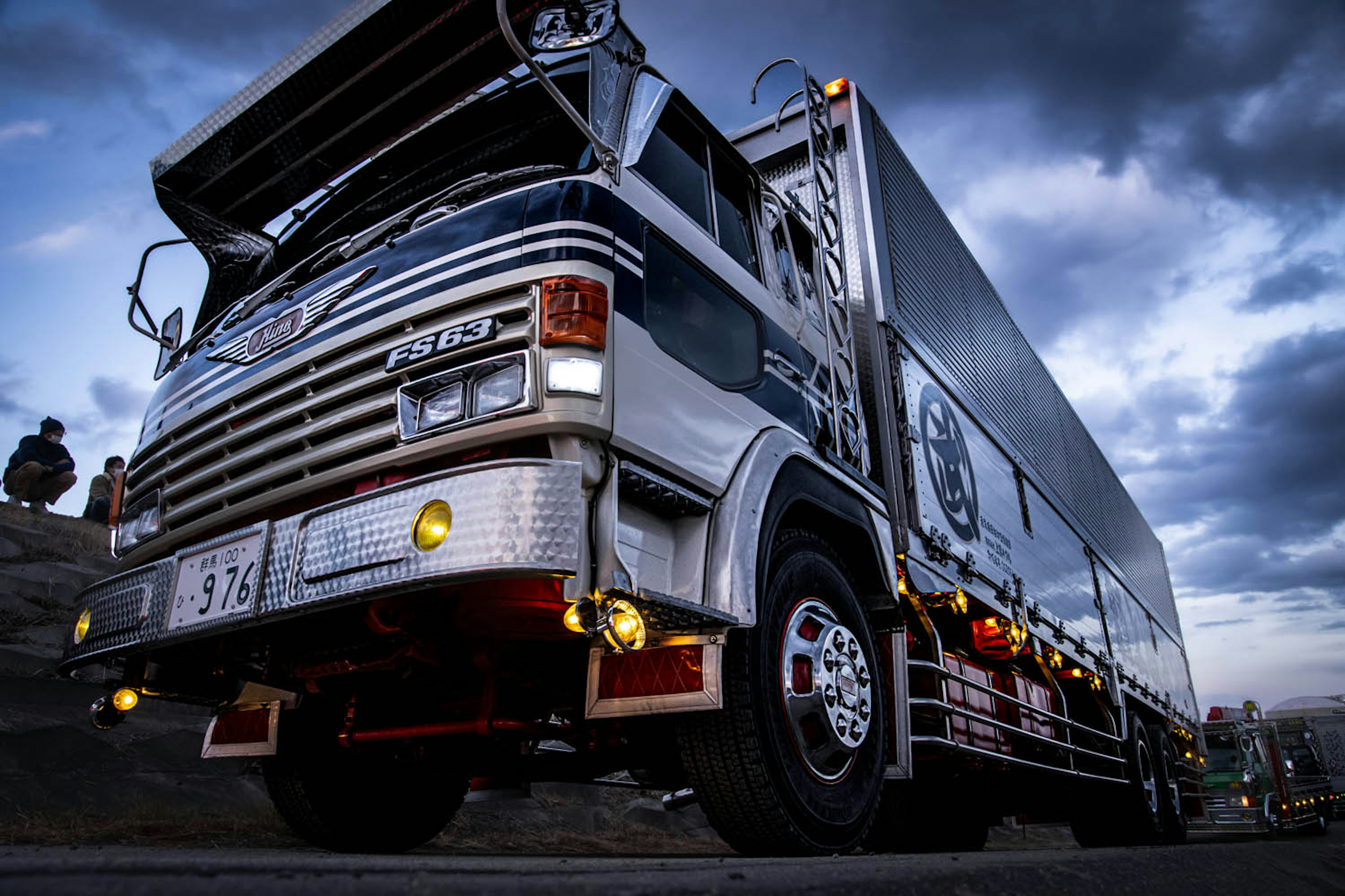 Close-up of a decorative truck under a dramatic sky