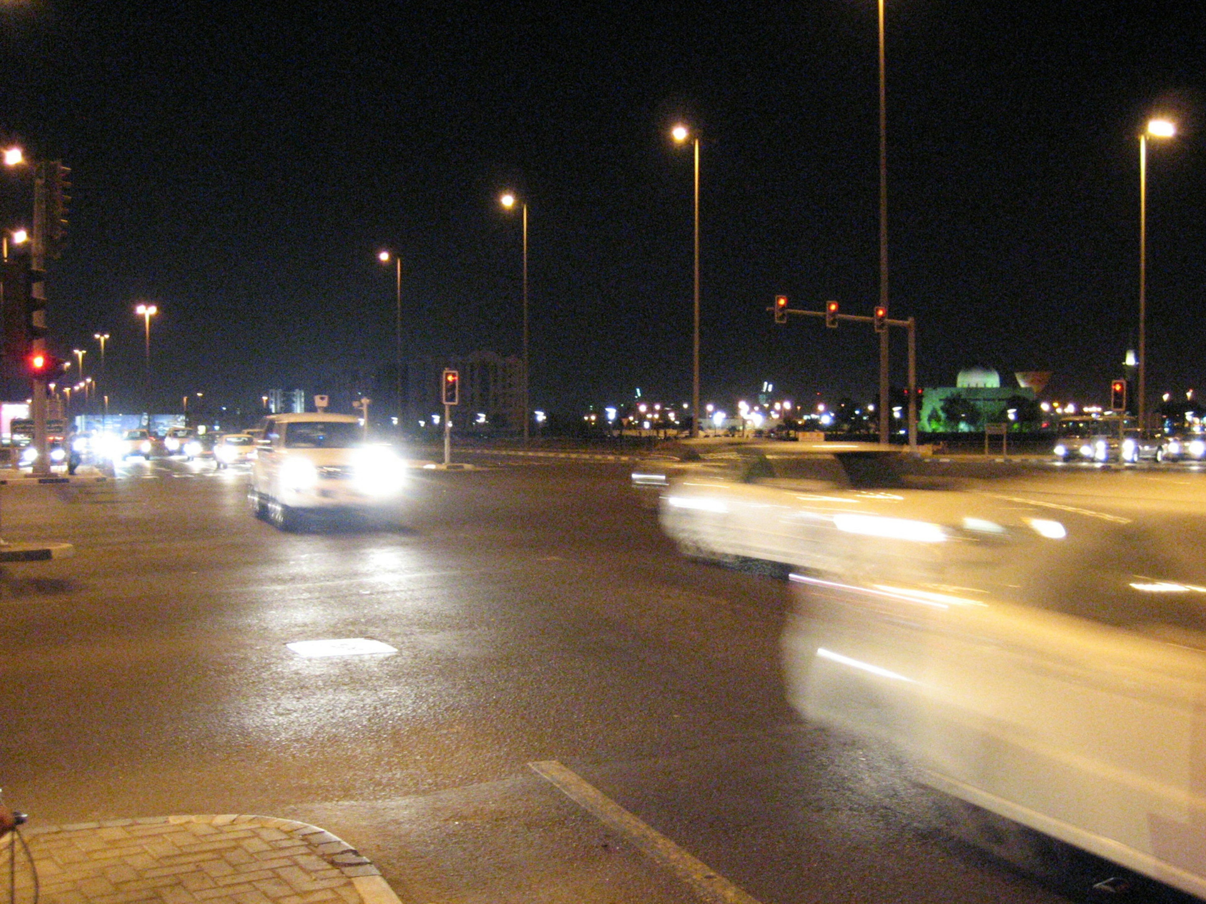 Traffic at a busy intersection at night with streetlights