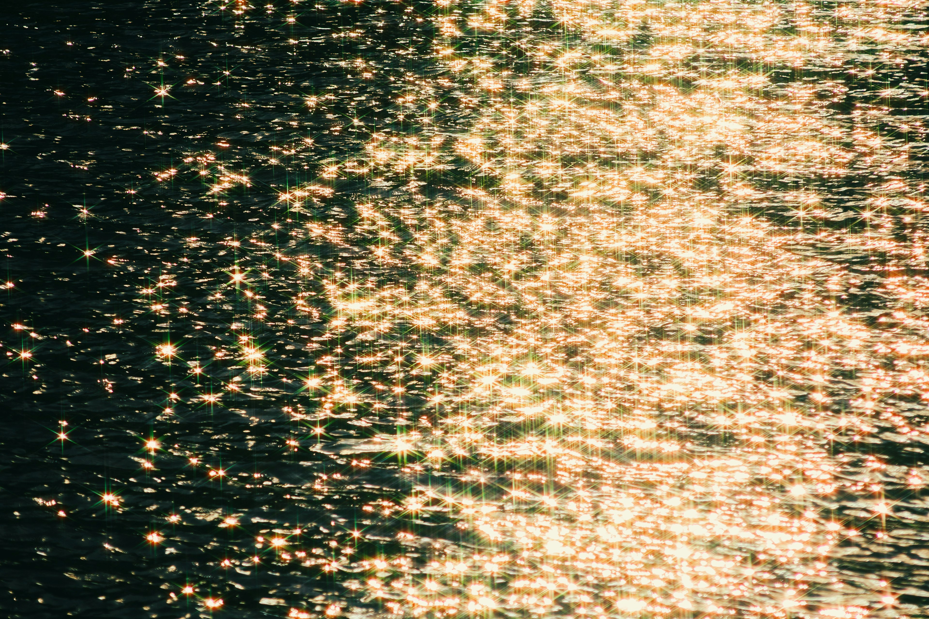 Glittering golden reflections on the water surface