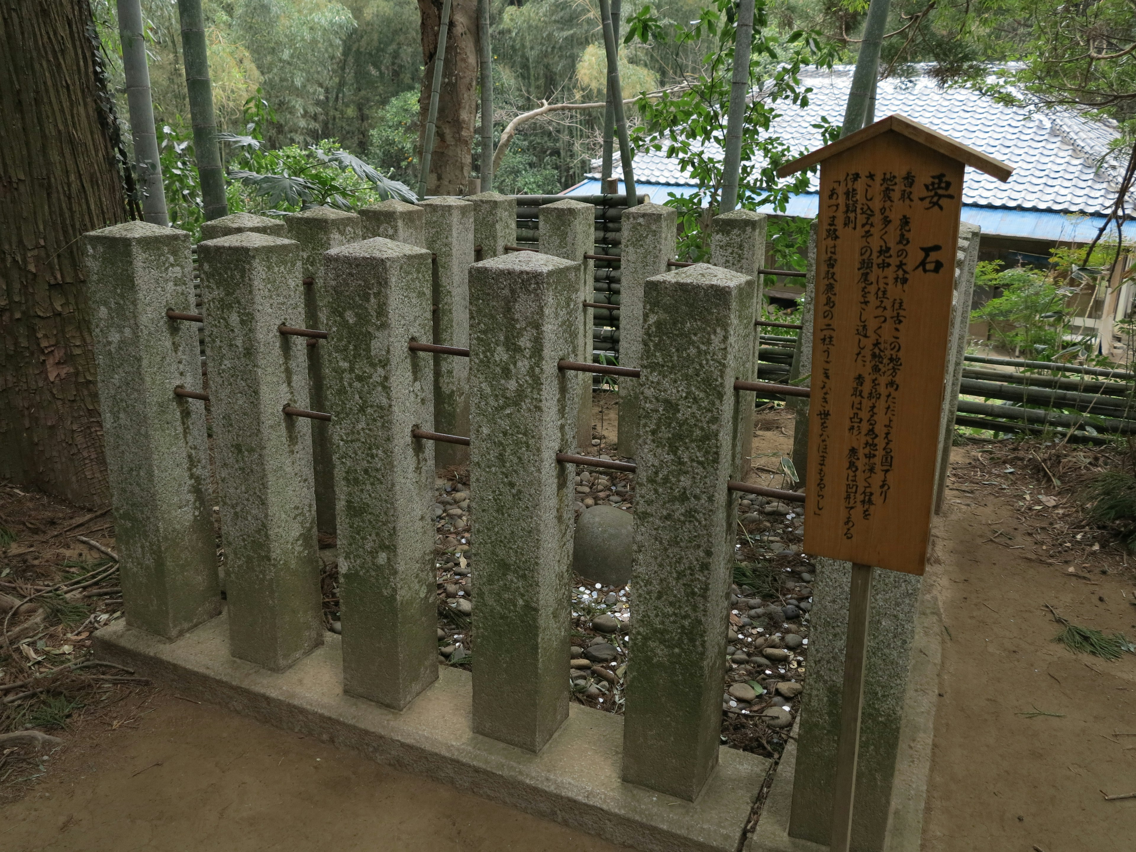 A serene location featuring stone columns and a wooden sign