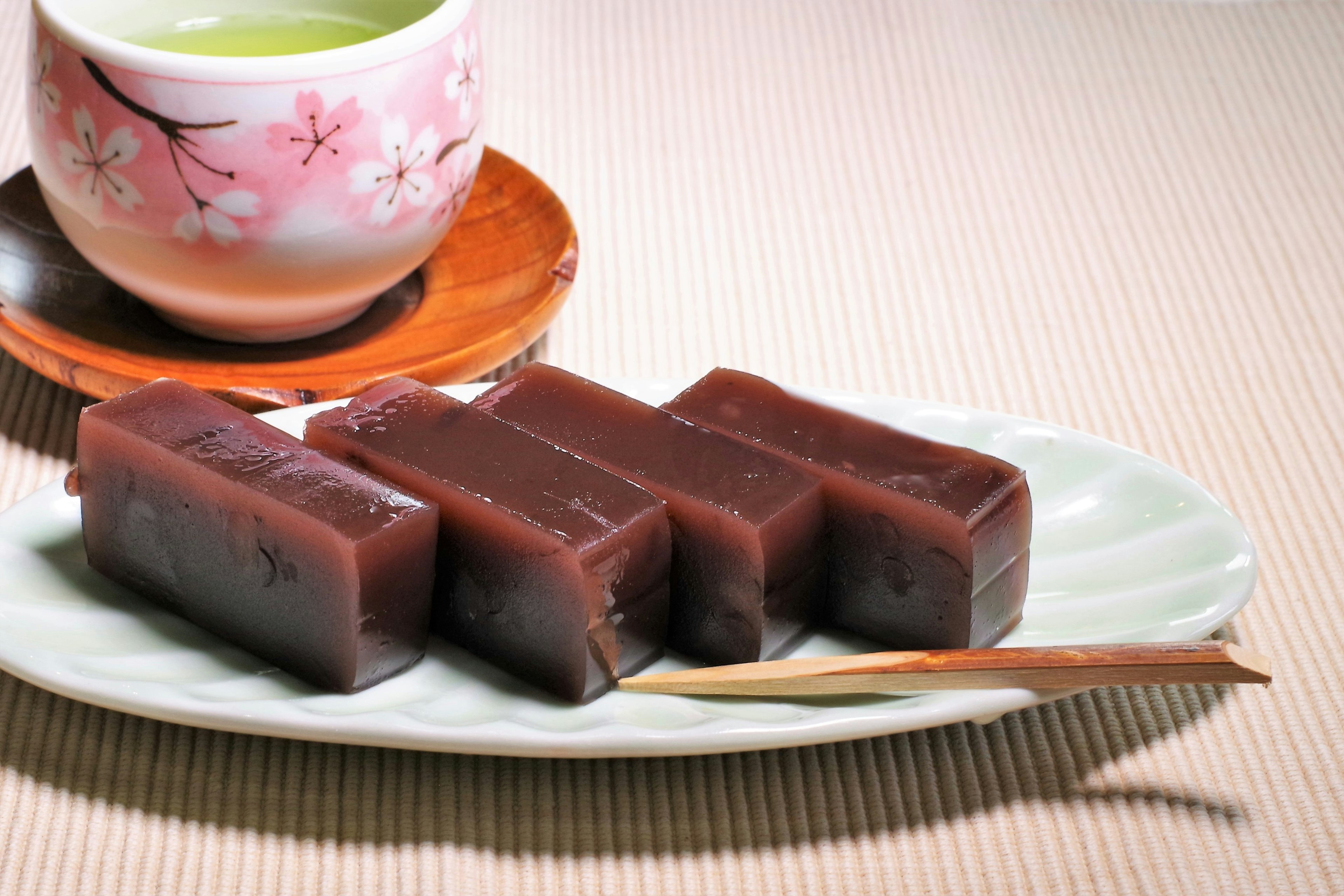 Beautifully arranged Japanese sweets beside green tea