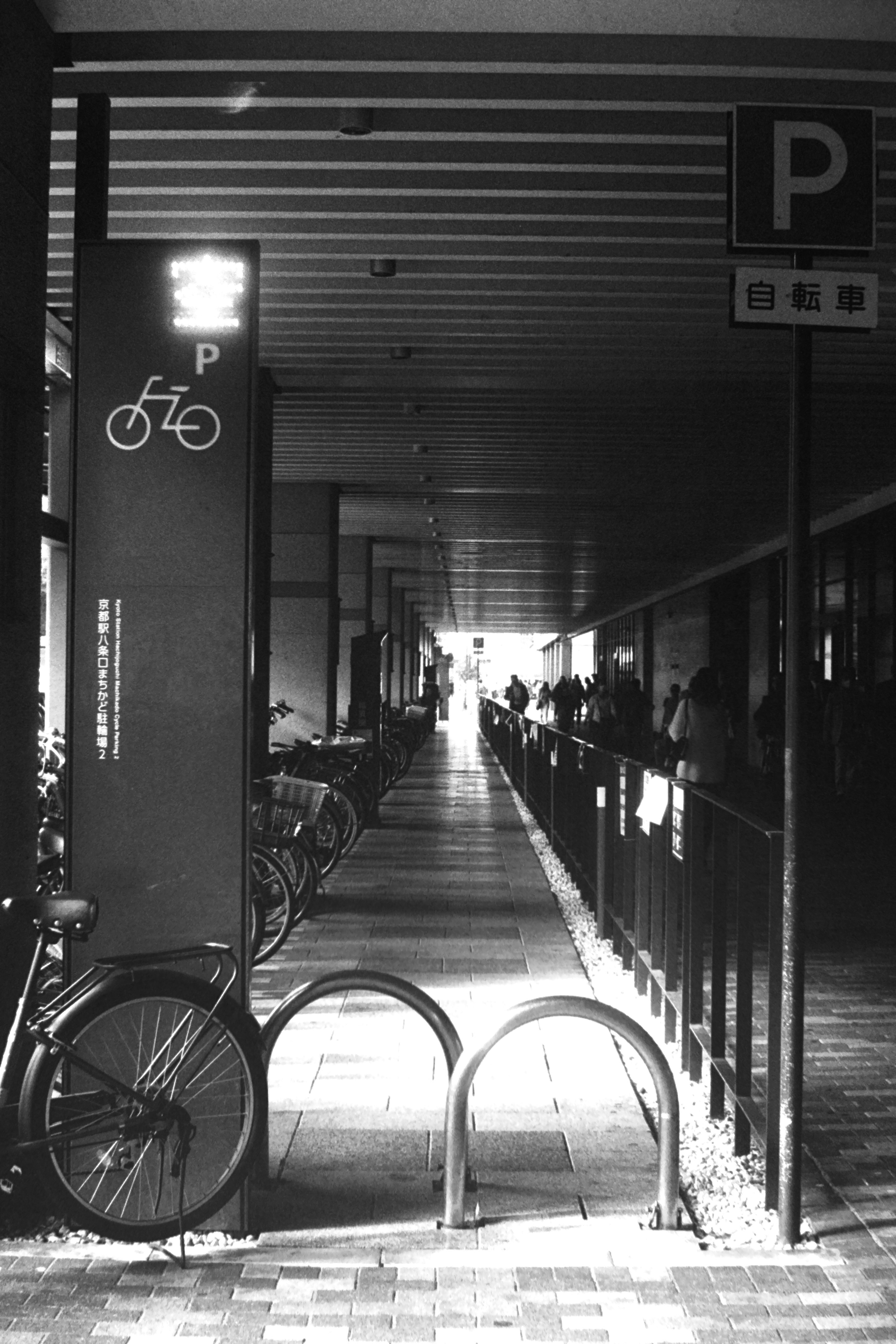 Dark corridor with bicycle parking sign and bikes