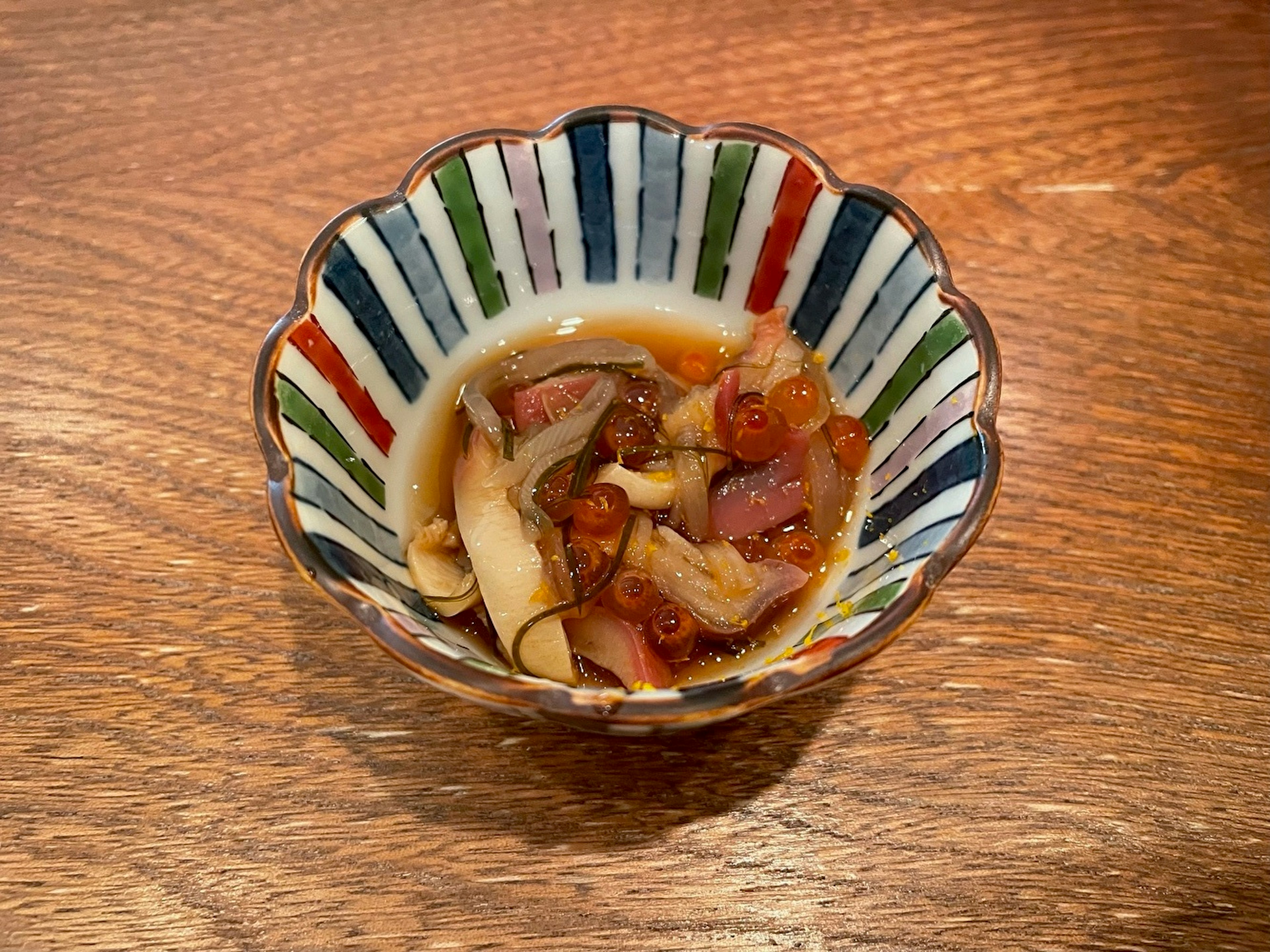 Colorful striped bowl with a Japanese dish inside