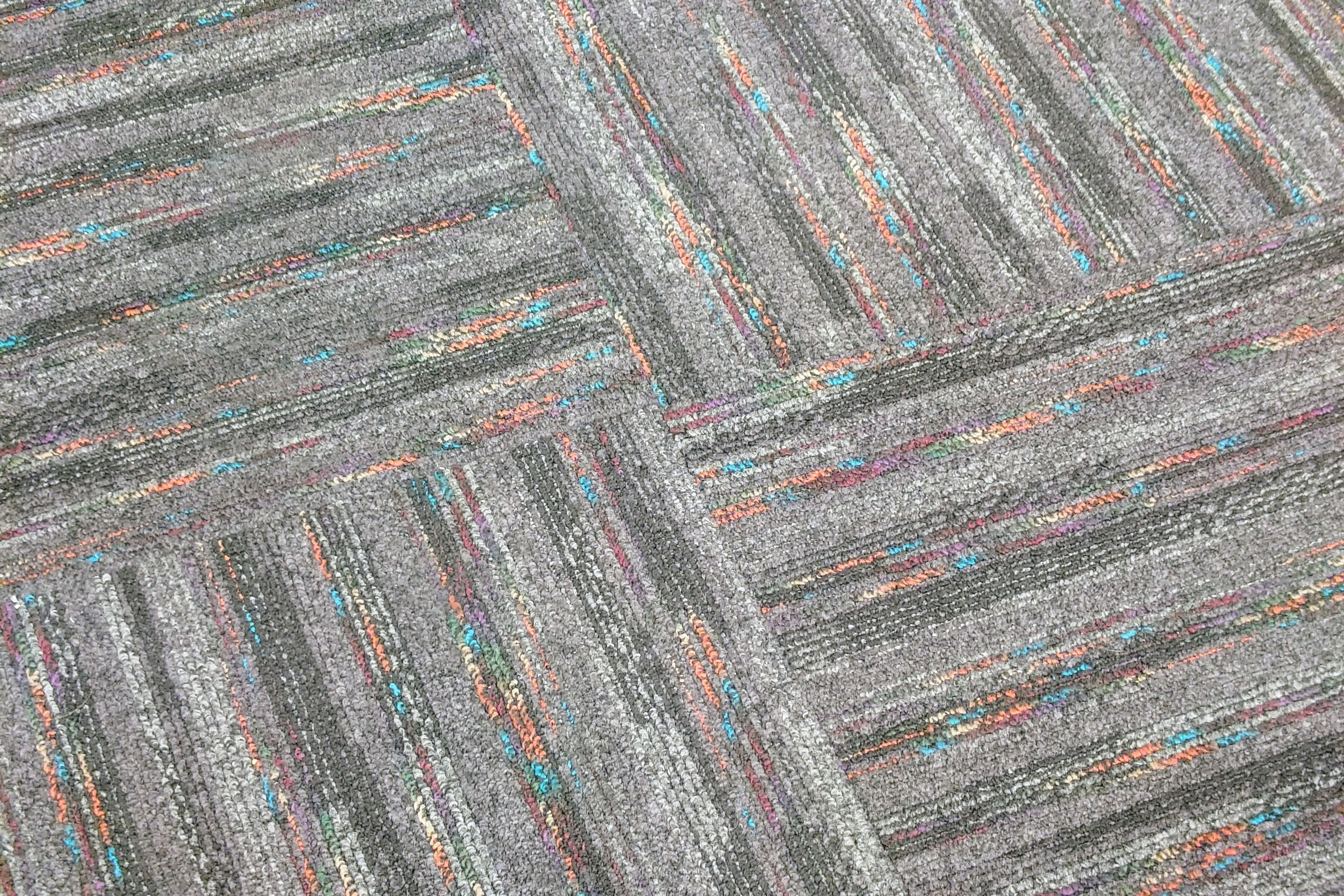 Gray tiled floor with colorful stripes visible