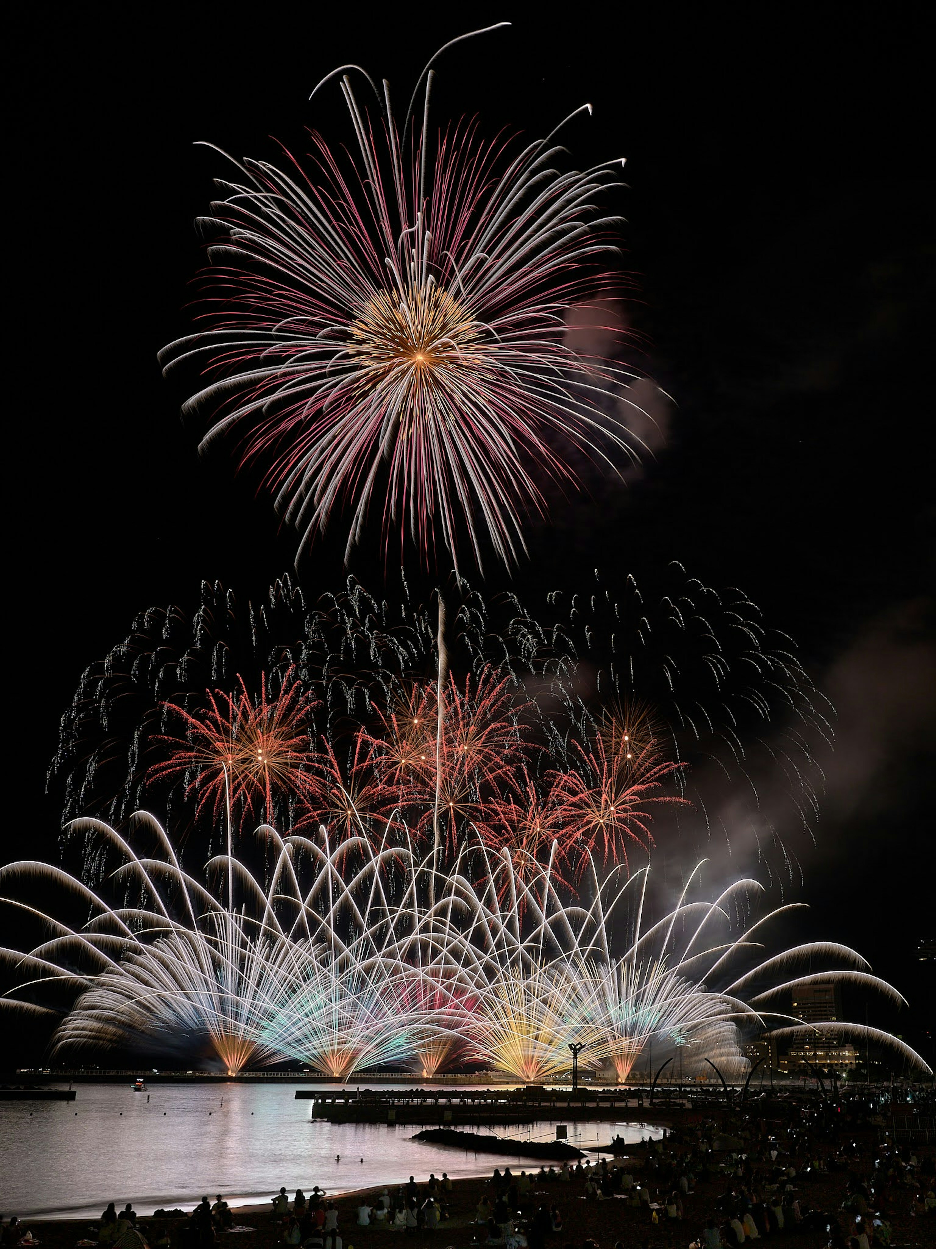 A spectacular fireworks display with colorful bursts lighting up the night sky