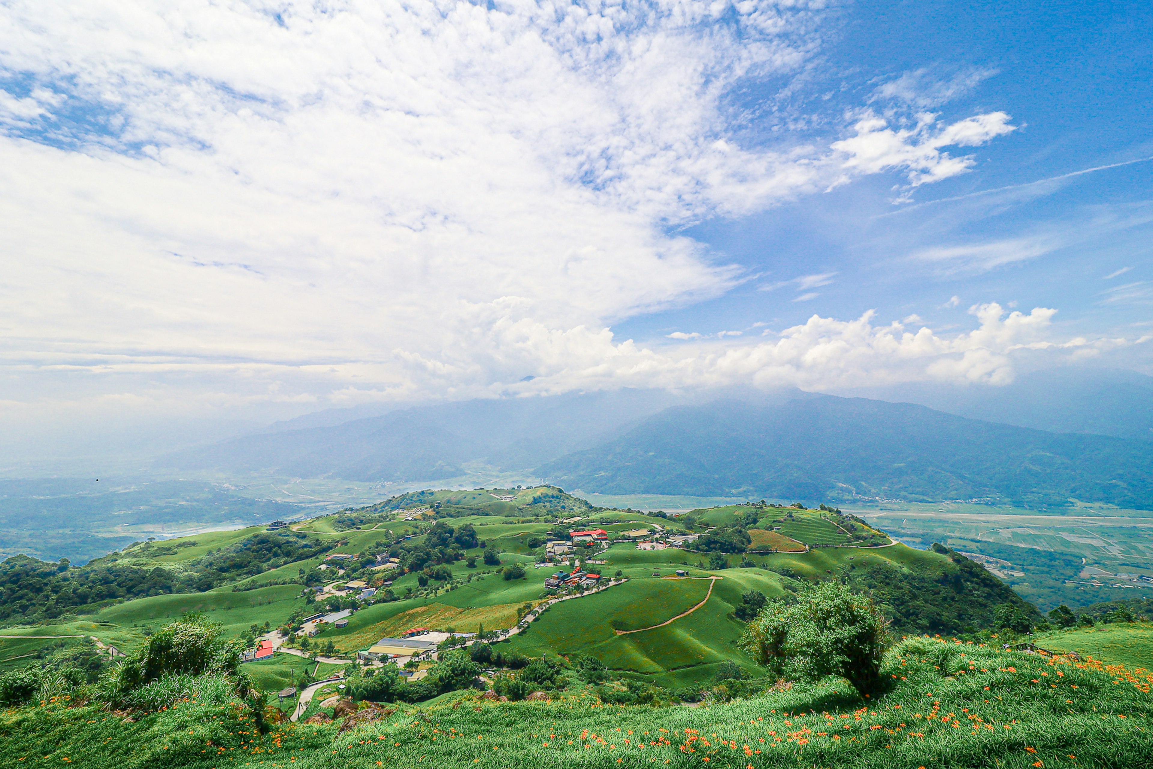 Panoramic view of green hills under a blue sky