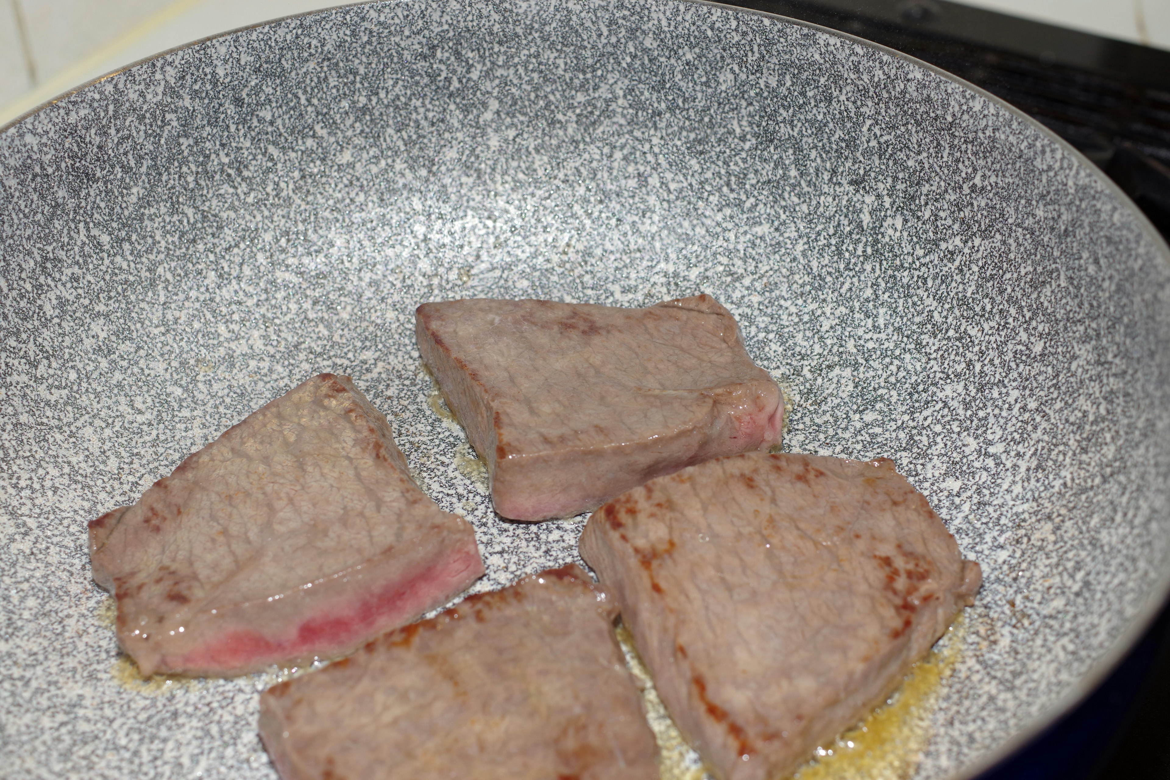 Image of meat chunks being cooked in a frying pan