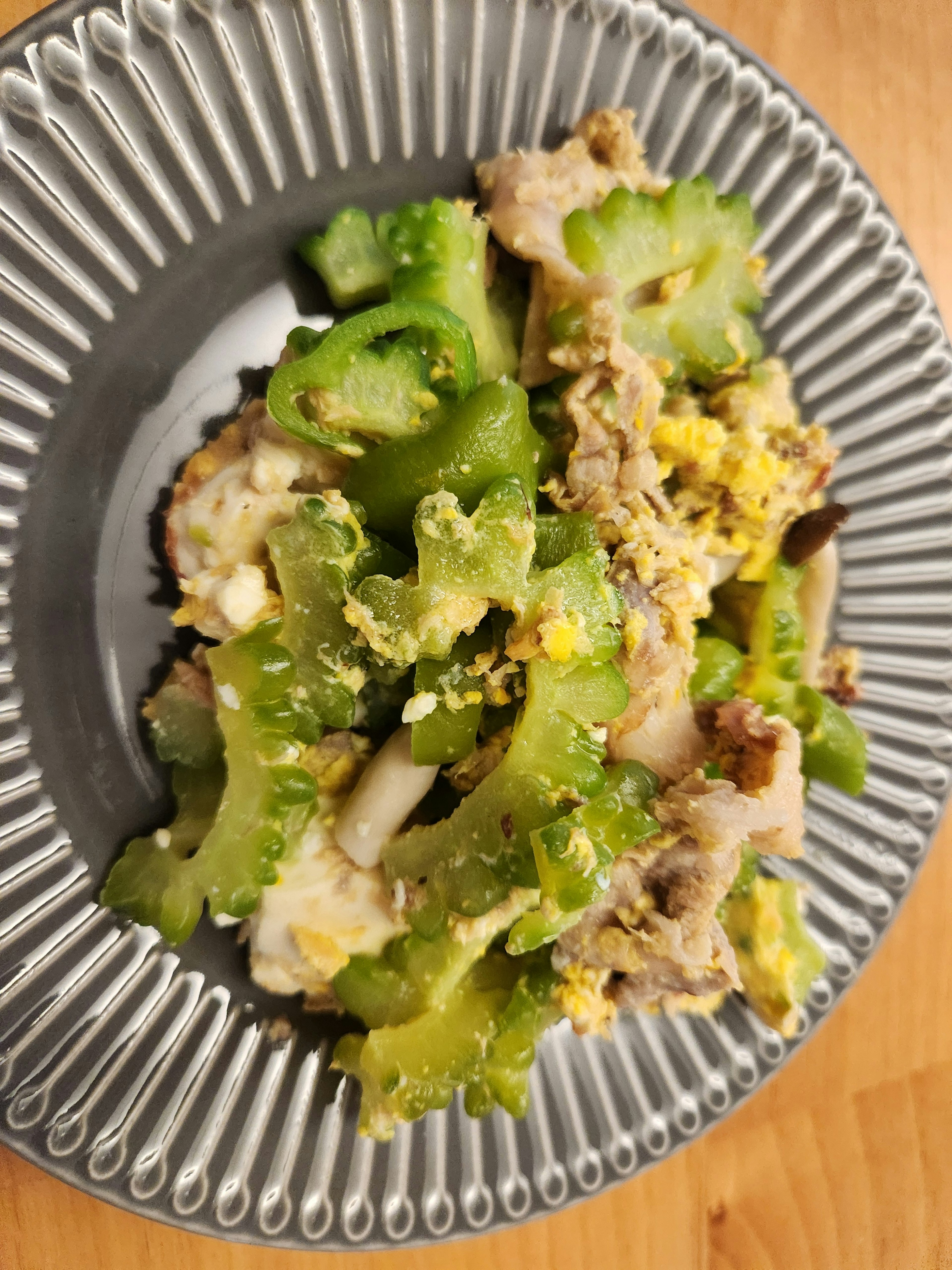 Un plat avec des légumes verts et des œufs servi dans une assiette argentée