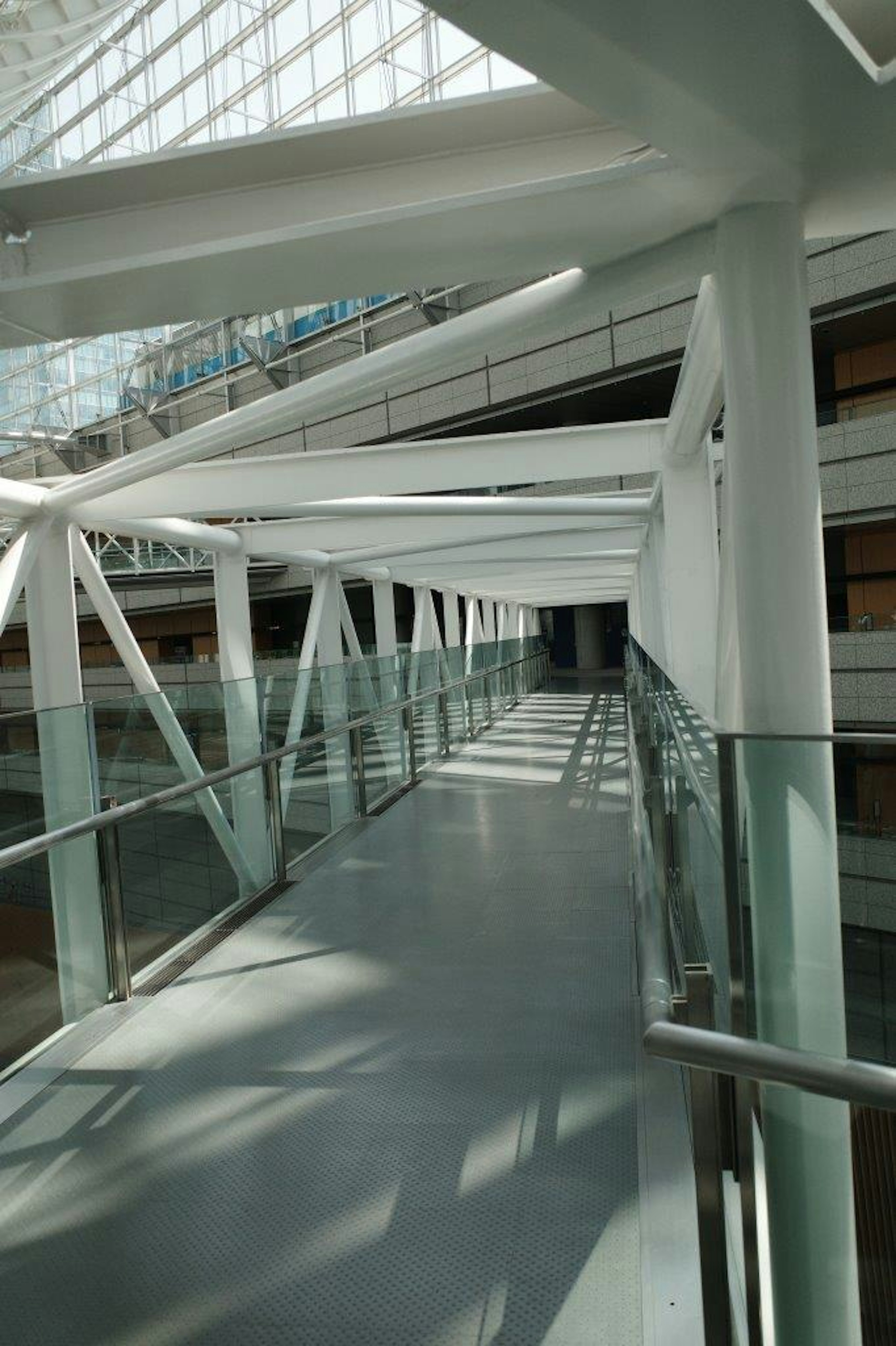 Modern building interior featuring a white structural glass walkway