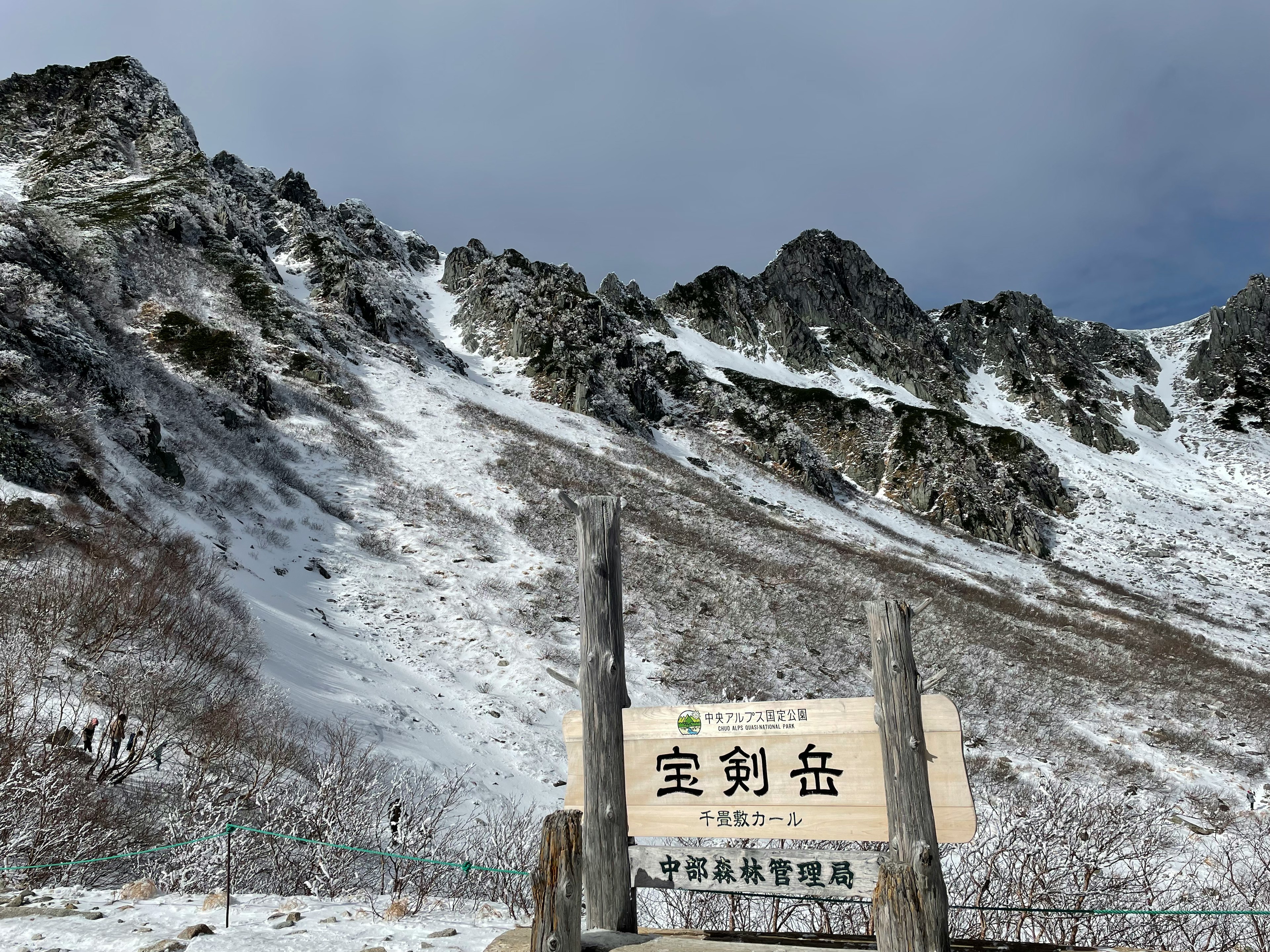 Snow-covered mountain landscape with a sign