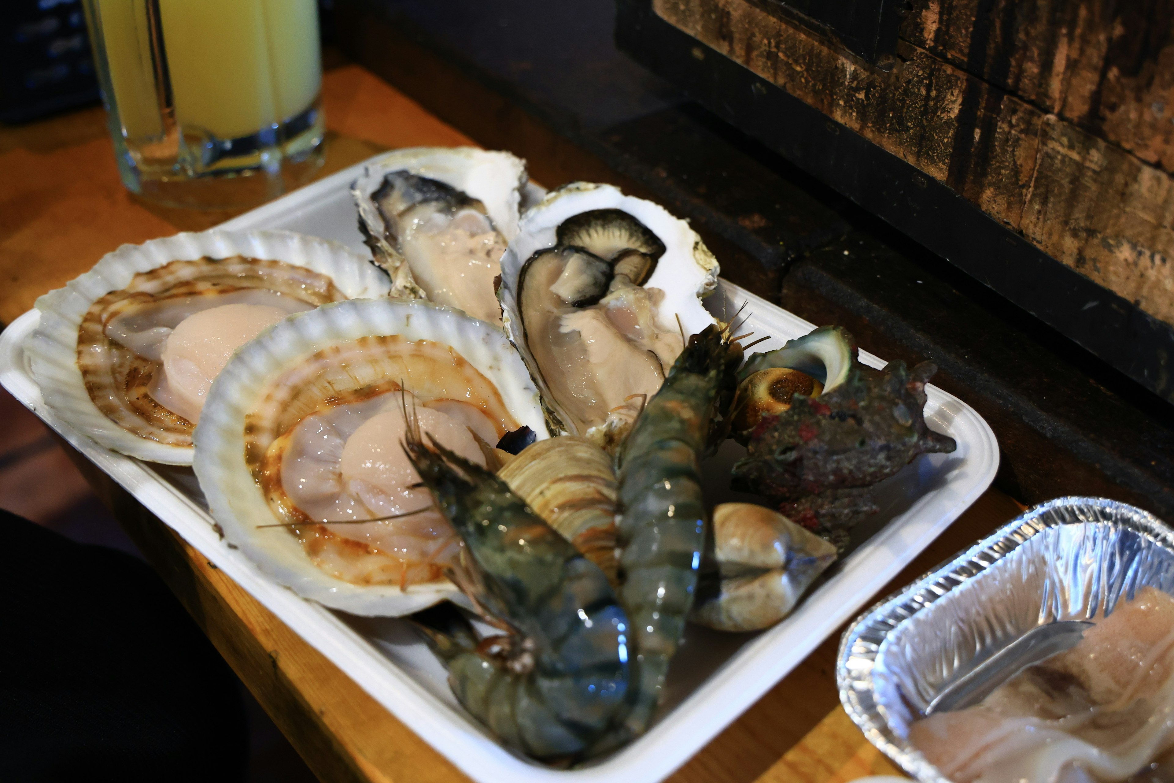 A platter of fresh seafood including scallops and shrimp