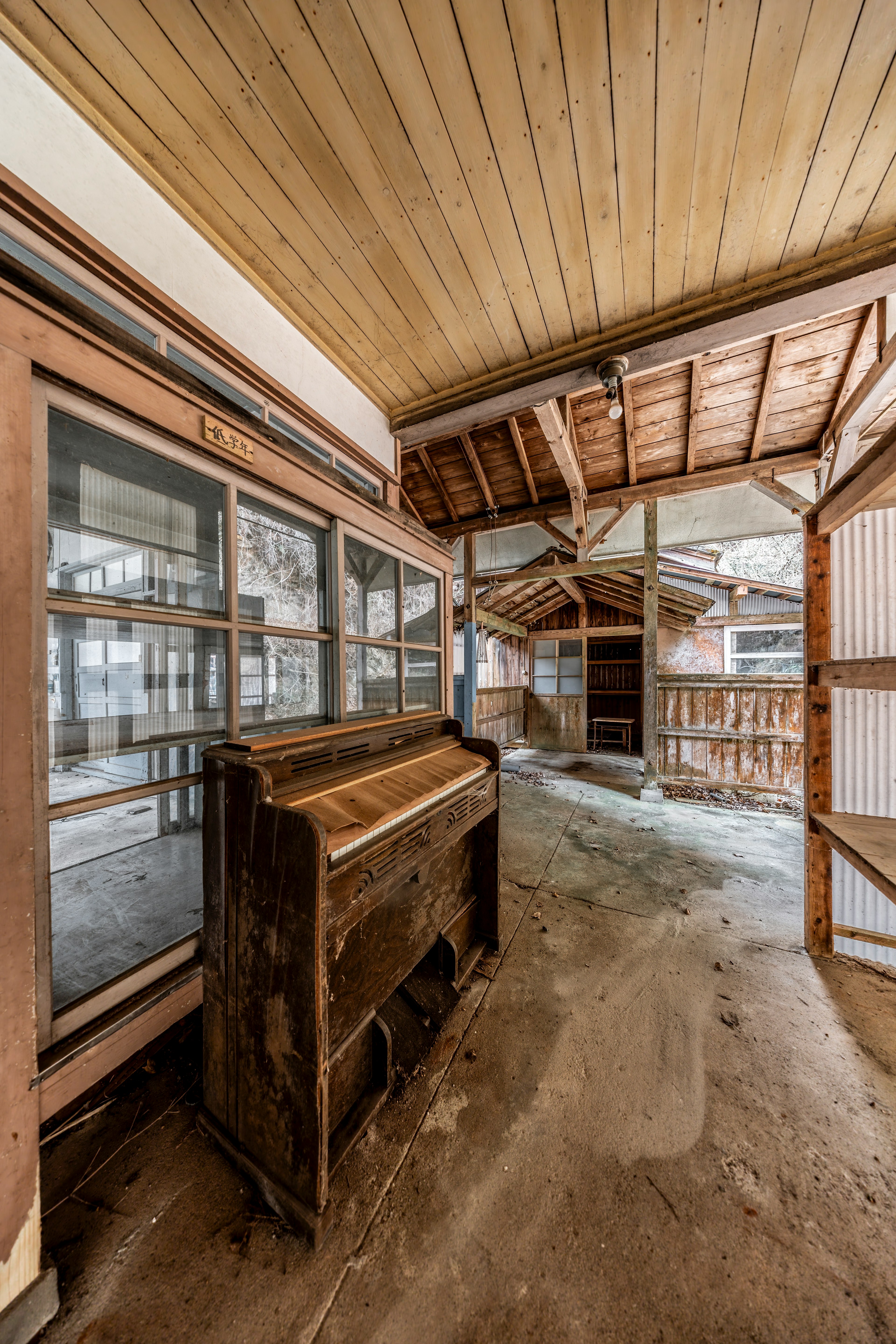 Interior hallway featuring an old piano and wooden shelves