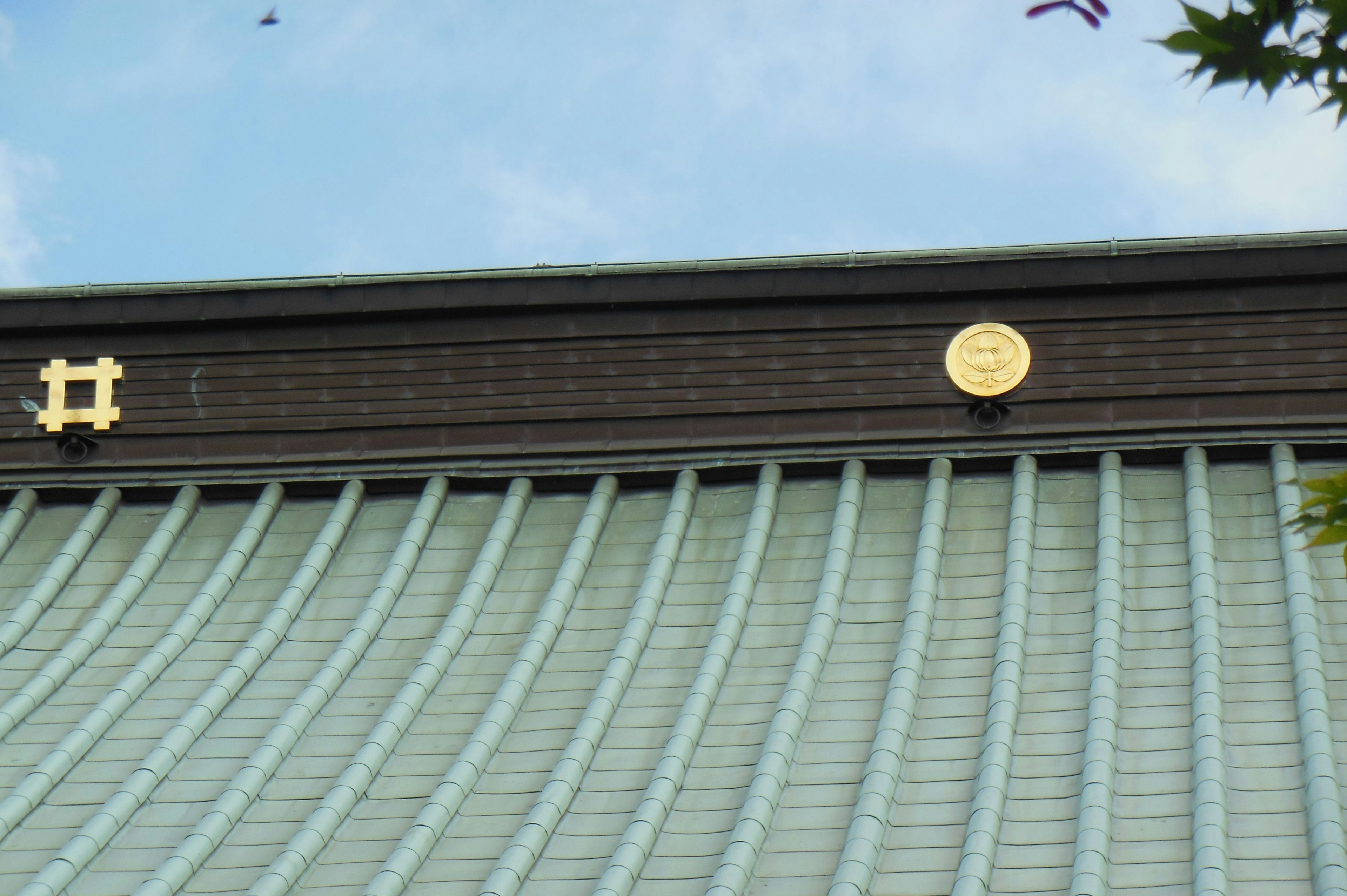 Building with a blue wave-patterned roof and golden embellishments