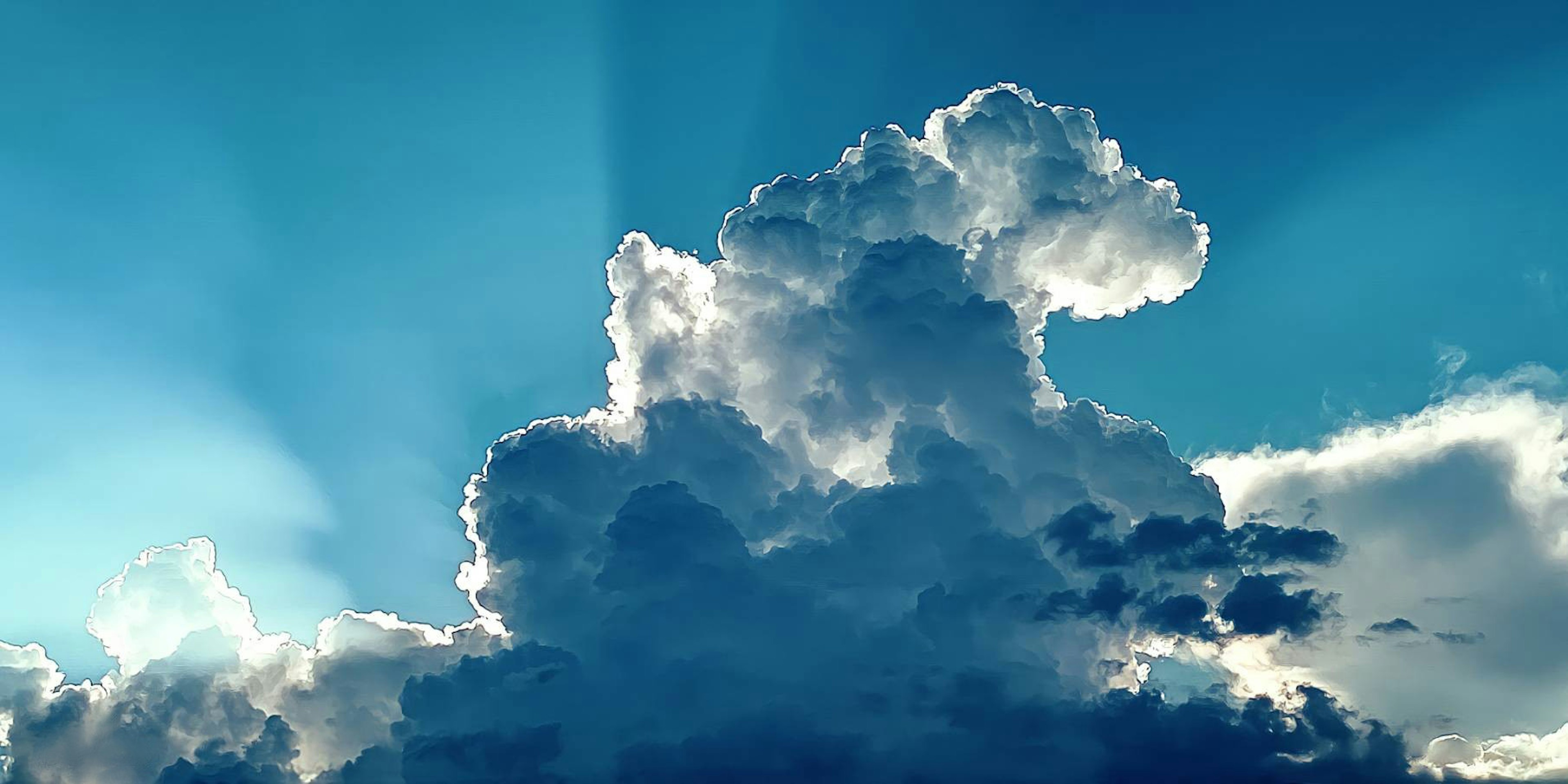 Nubes blancas flotando en un cielo azul con rayos de luz