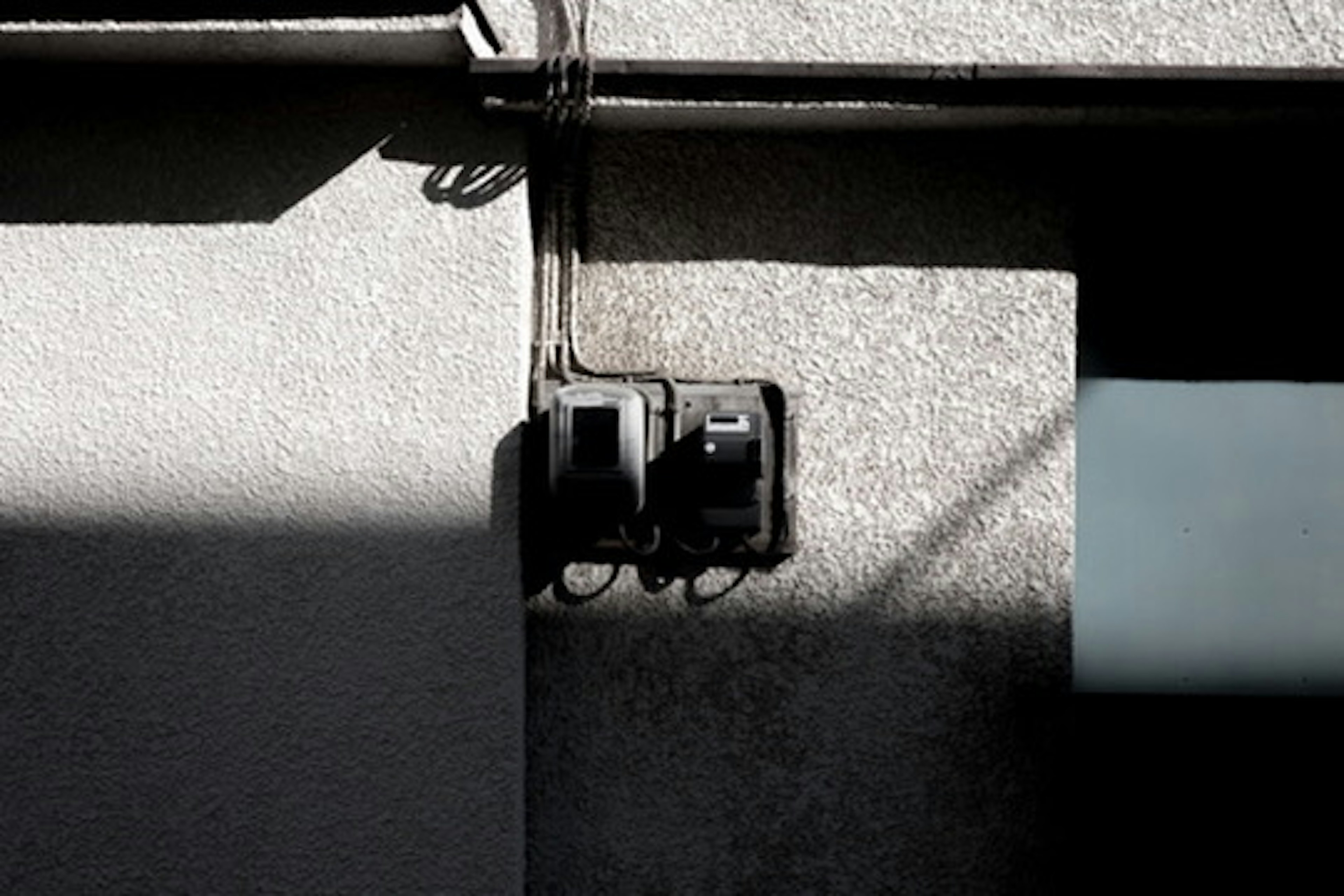 Close-up of an electric meter and wiring mounted on a wall